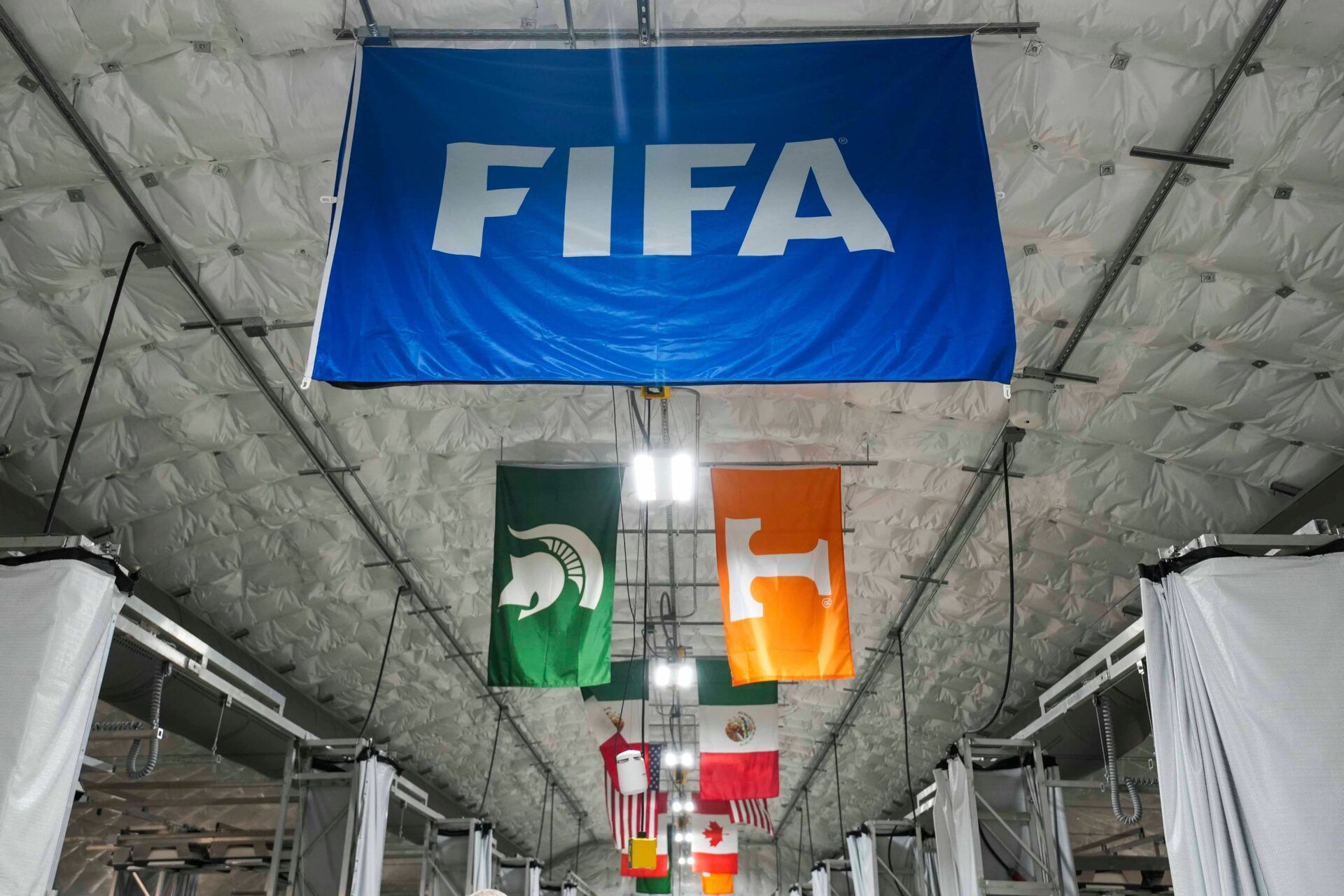 Flags of participating universities and countries with FIFA hang inside the research area for turf for the 2026 FIFA World Cup at the University of Tennessee's East Tennessee AgResearch and Education Center-Plant Sciences Unit on Oct. 21, 2025.