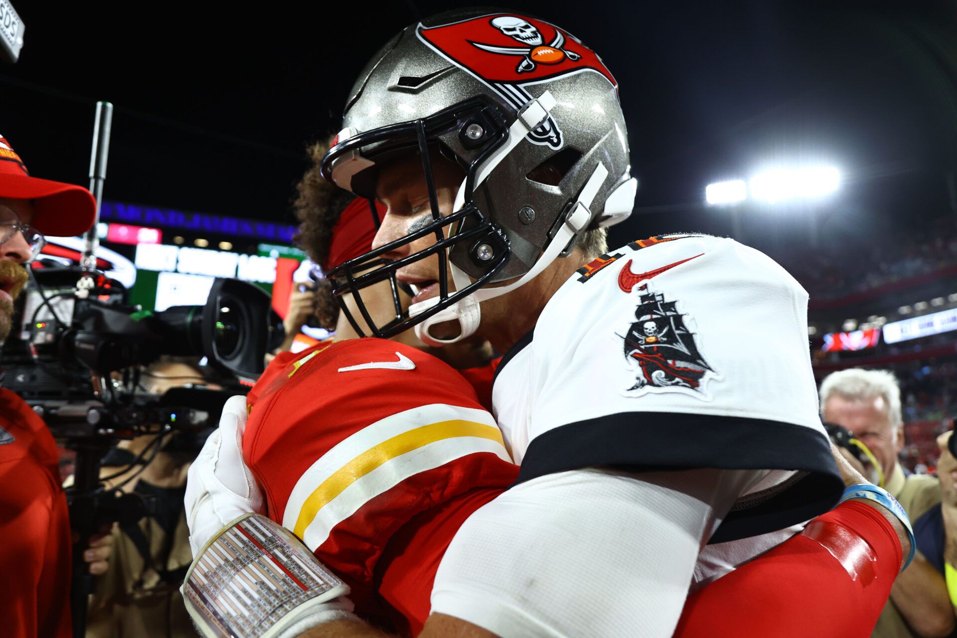 Tampa Bay Buccaneers quarterback Tom Brady (12) and  Kansas City Chiefs quarterback Patrick Mahomes (15) greet after the game at Raymond James Stadium.