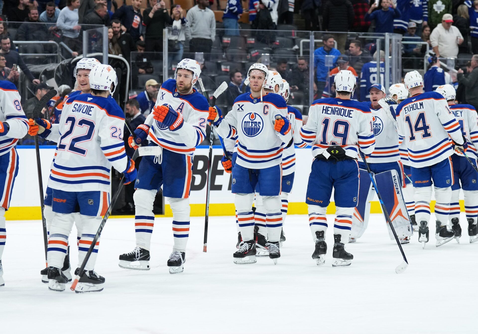 Edmonton Oilers center Connor McDavid (97) celebrates the win with center Adam Henrique (19) against the Toronto Maple Leafs at the end of the third period at Scotiabank Arena.