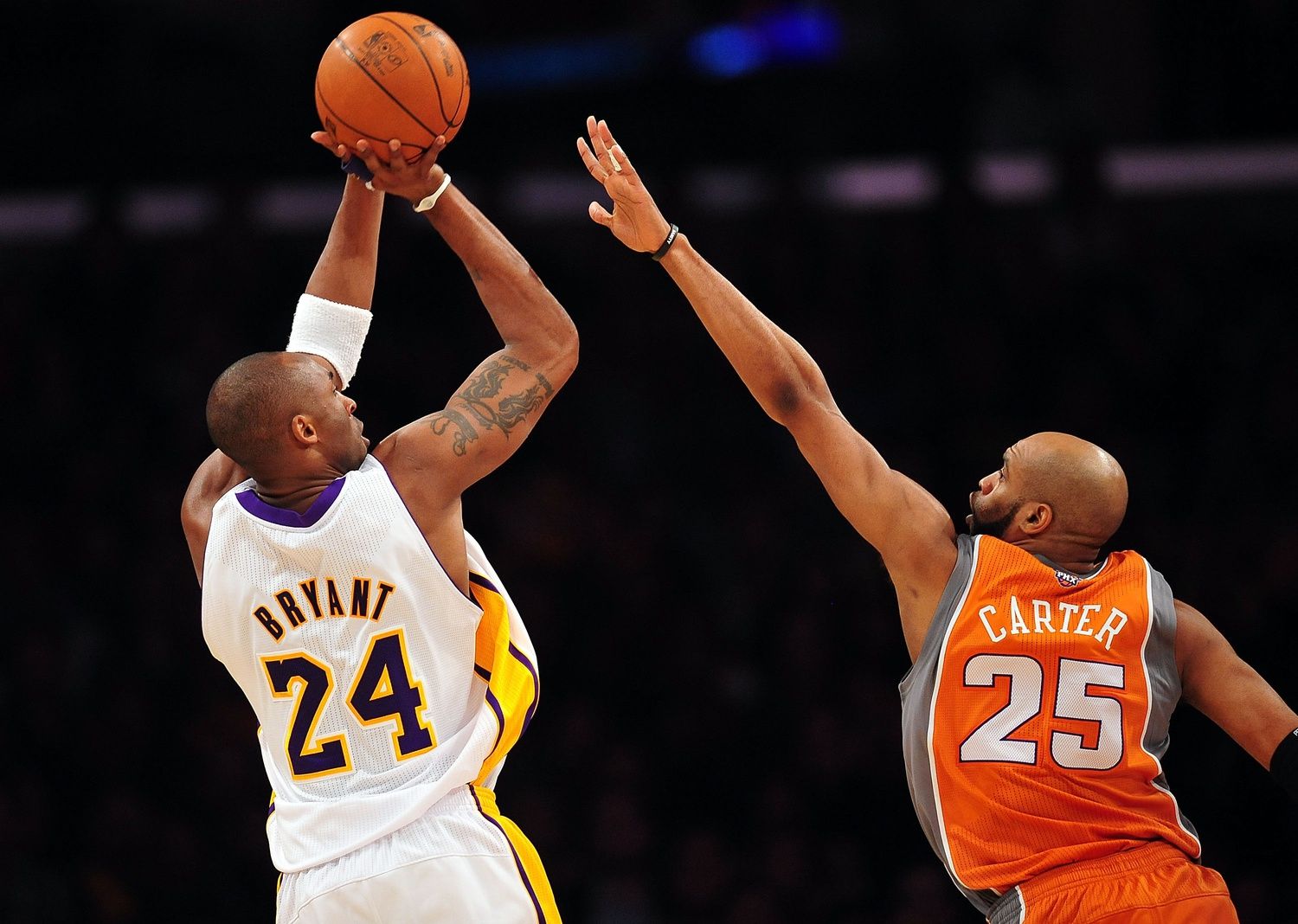 Los Angeles Lakers shooting guard Kobe Bryant (24) shoots a basket against the defense of Phoenix Suns shooting guard Vince Carter (25) during the first half at the Staples Center.