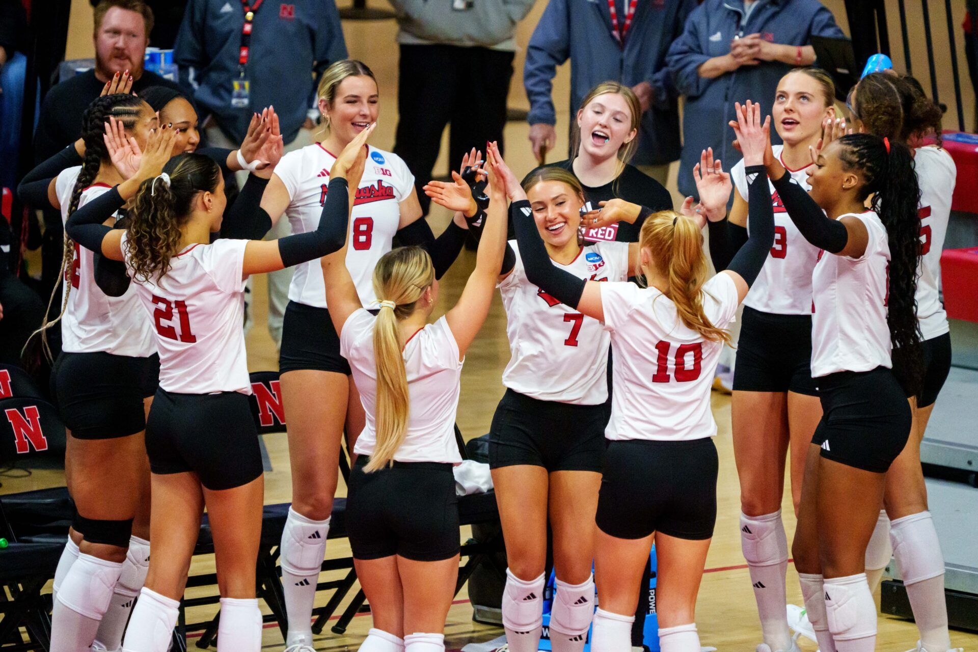The Nebraska Cornhuskers cheer after a point against the Kansas Jayhawks during the second set at Bob Devaney Sports Center.