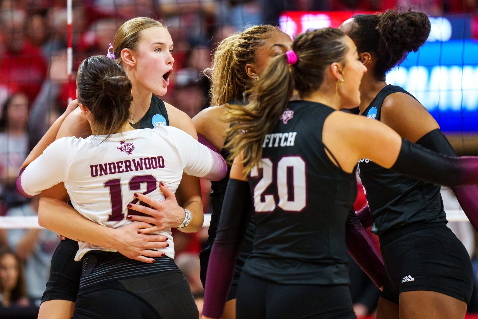 Texas A&M Aggies outside hitter Emily Hellmuth (4) and libero Ava Underwood (12) embrace after a point against the Nebraska Cornhuskers during the fifth set at Bob Devaney Sports Center.