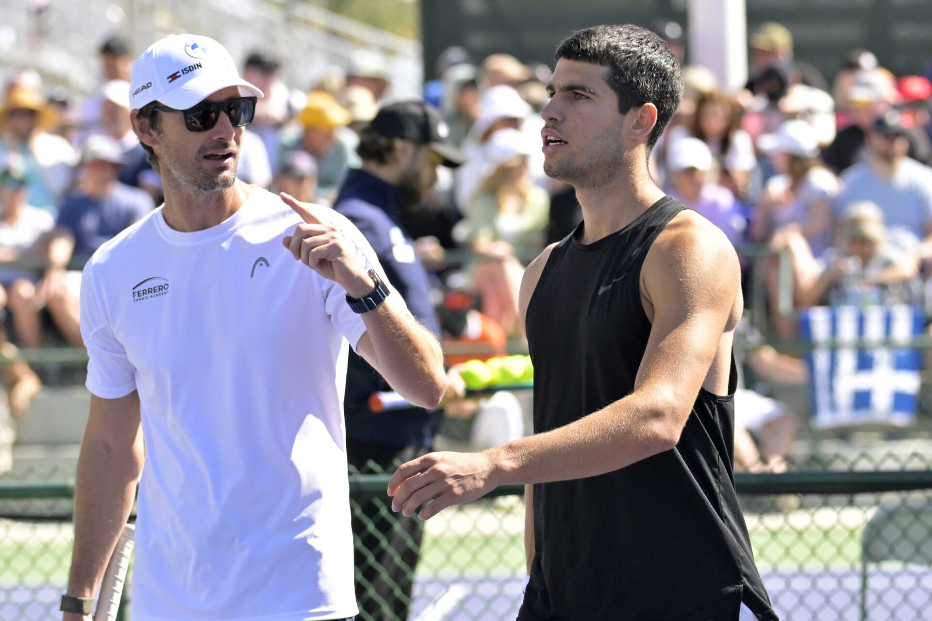 Tennis coach Juan Carlos Ferrero talks with Carlos Alcaraz (ESP) on the practice courts during the BNP Paribas Open at the Indian Wells Tennis Garden.