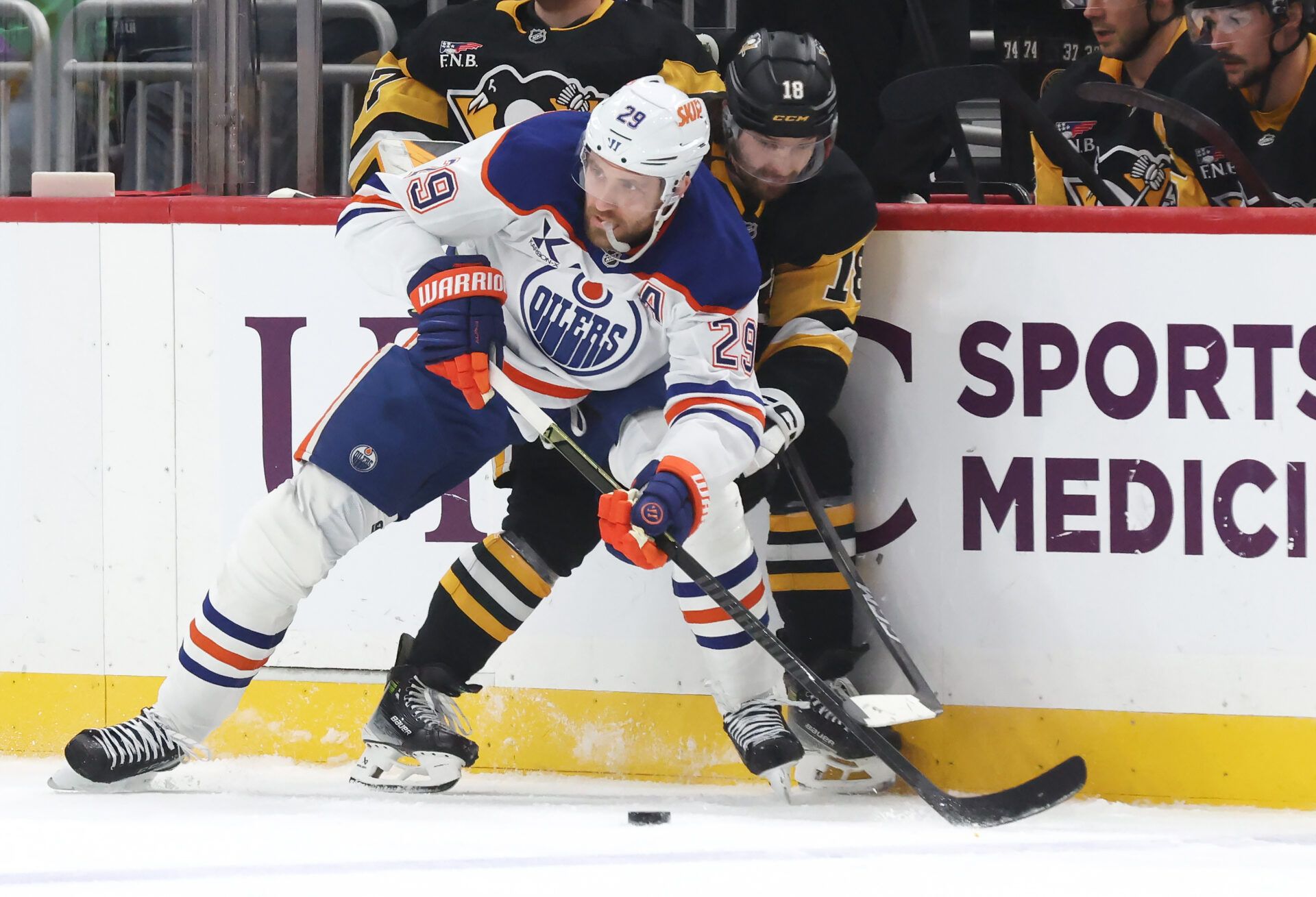 Edmonton Oilers center Leon Draisaitl (29) and Pittsburgh Penguins center Tommy Novak (18) battle for the puck during the first period at PPG Paints Arena.