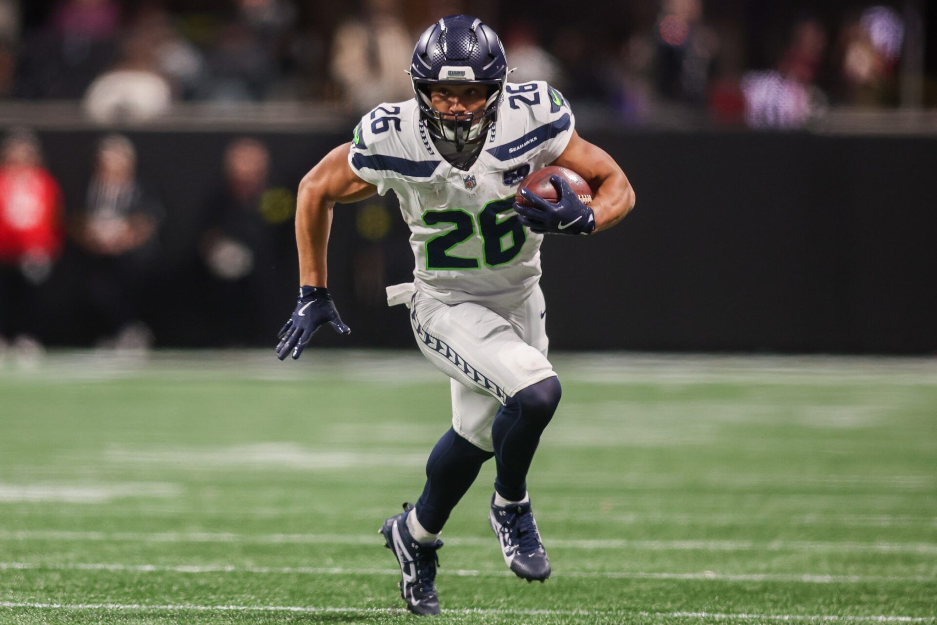 Seattle Seahawks running back Zach Charbonnet (26) runs the ball against the Atlanta Falcons in the fourth quarter at Mercedes-Benz Stadium.