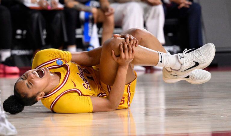 USC Trojans guard JuJu Watkins (12) grabs her knee after falling g to the floor during the first quarter of an NCAA Tournament second round game against the Mississippi State Bulldogs at Galen Center.