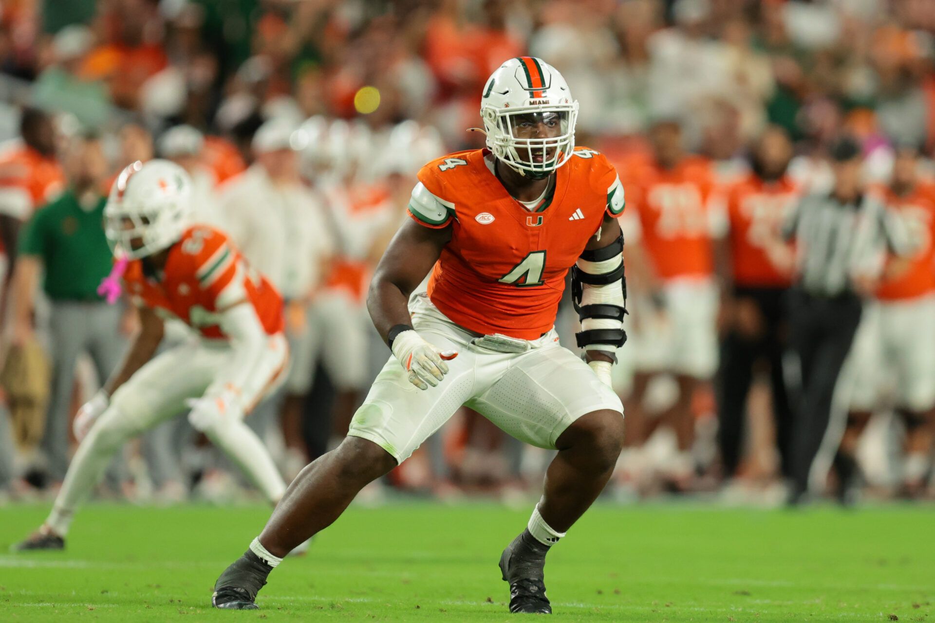Miami Hurricanes defensive lineman Rueben Bain Jr. (4) plays his position against the Louisville Cardinals during the third quarter at Hard Rock Stadium.