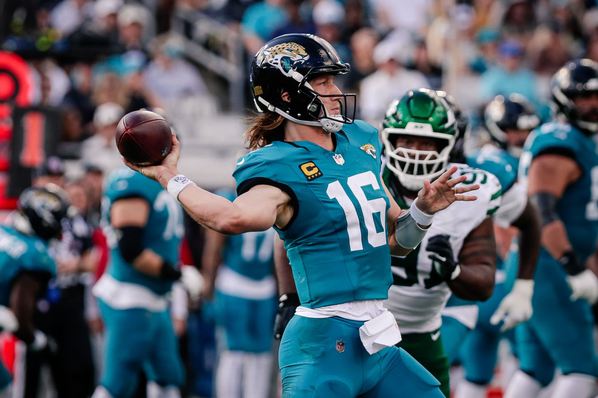 Jacksonville Jaguars quarterback Trevor Lawrence (16) drops back to pass against the New York Jets at EverBank Stadium.