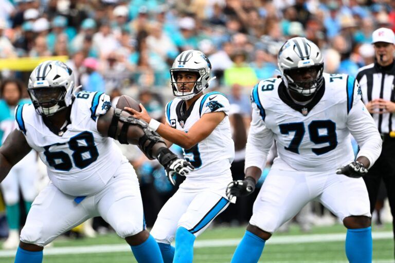 Carolina Panthers quarterback Bryce Young (9) with the ball as guard Damien Lewis (68) and offensive tackle Ikem Ekwonu (79) block in the second quarter at Bank of America Stadium.