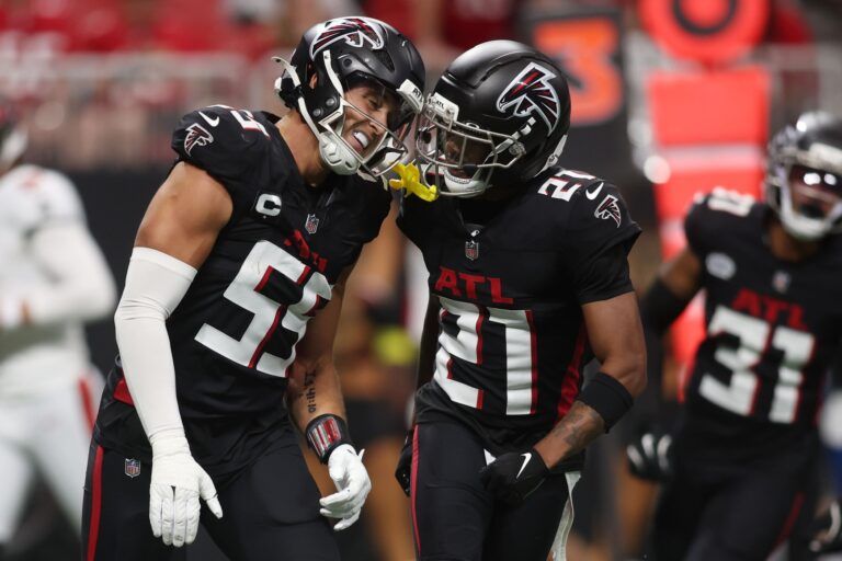 Atlanta Falcons linebacker Kaden Elliss (left) celebrates with cornerback Mike Hughes (21) after making a tackle against the Tampa Bay Buccaneers during the first quarter at Mercedes-Benz Stadium.