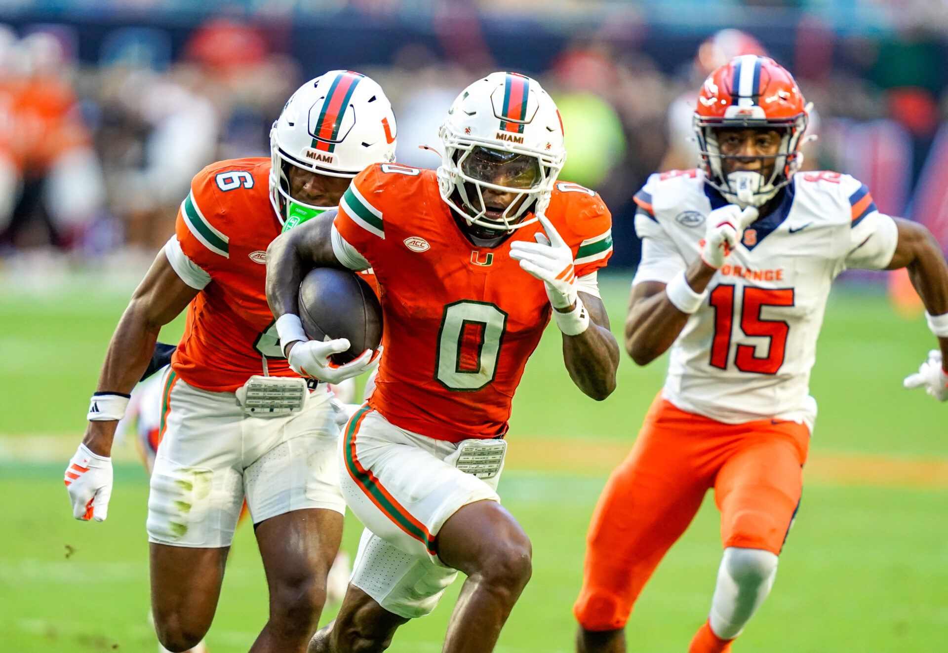 Miami Hurricanes defensive back Keionte Scott (0) returns an interception for a touchdown in a game against the Syracuse Orange during the second quarter at Hard Rock Stadium.