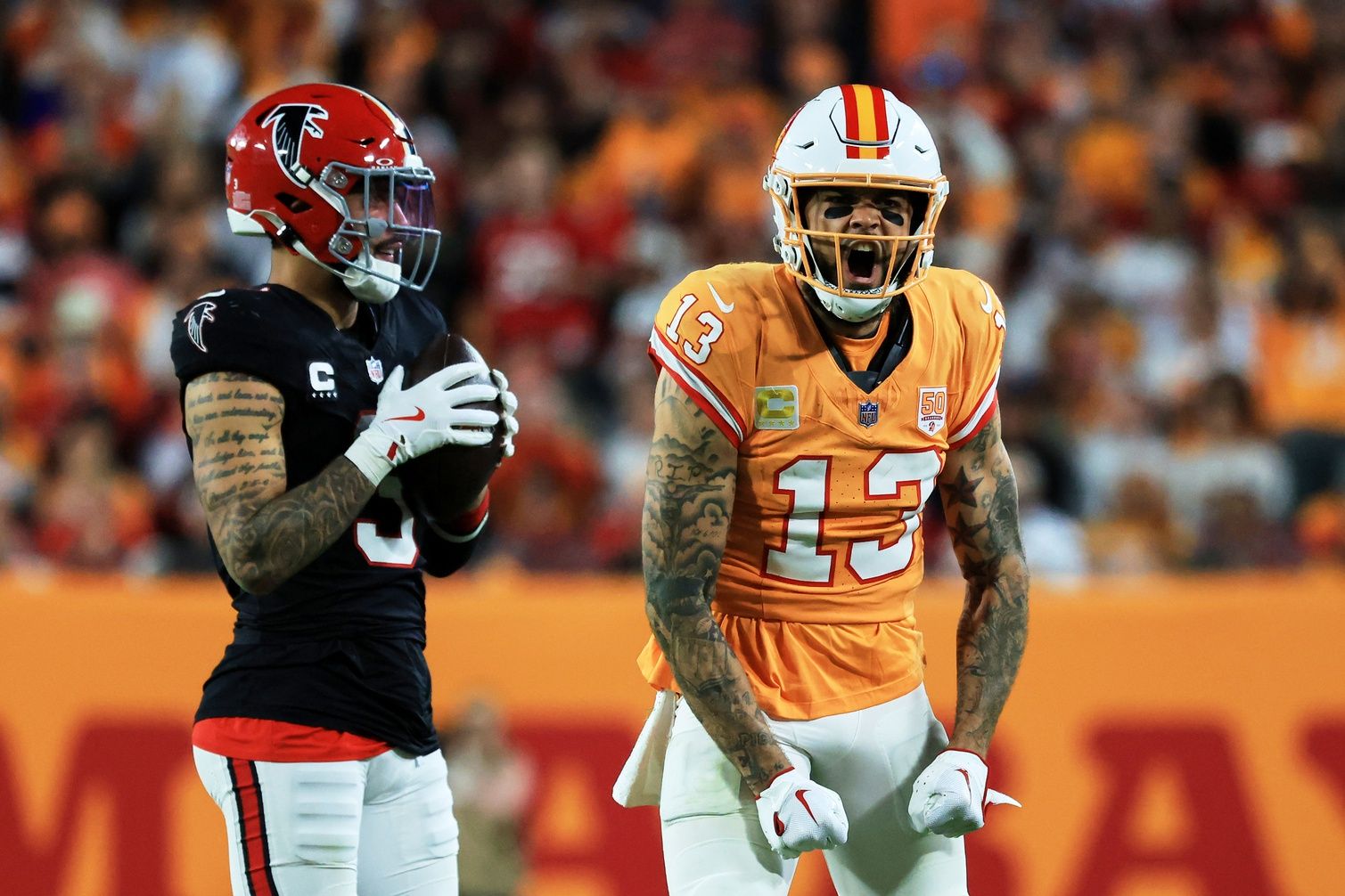 Tampa Bay Buccaneers wide receiver Mike Evans (13) reacts after catching a pass against Atlanta Falcons safety Jessie Bates III (3) (obscured) during the third quarter at Raymond James Stadium.
