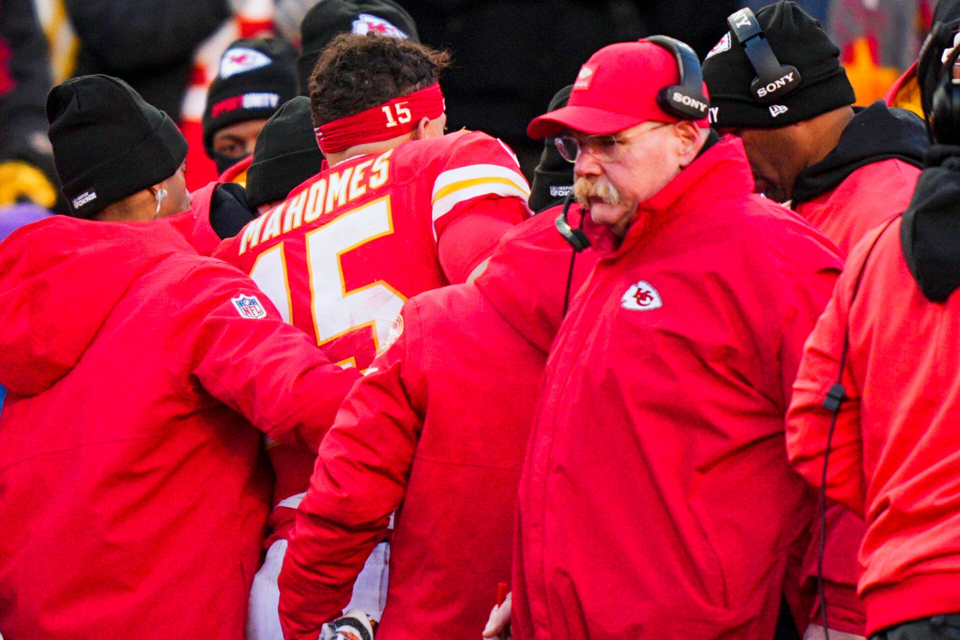Kansas City Chiefs quarterback Patrick Mahomes (15) is attended to by team medical staff following an injury during the fourth quarter against the Los Angeles Chargers at GEHA Field at Arrowhead Stadium. Kansas City Chiefs head coach Andy Reid, second from right, stands on the sideline