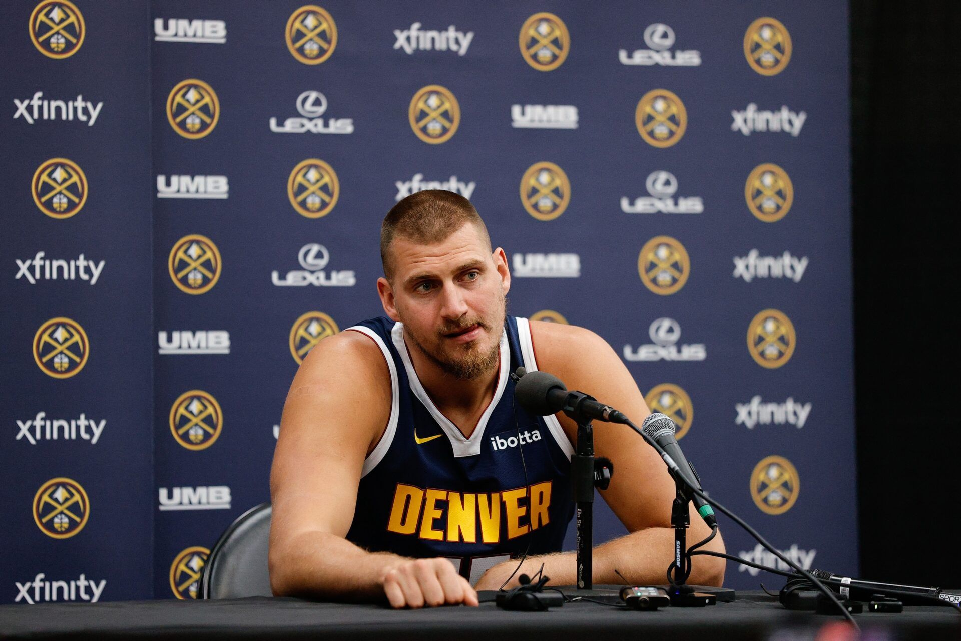 Denver Nuggets player Nikola Jokic (15) takes questions during media day at Ball Arena.
