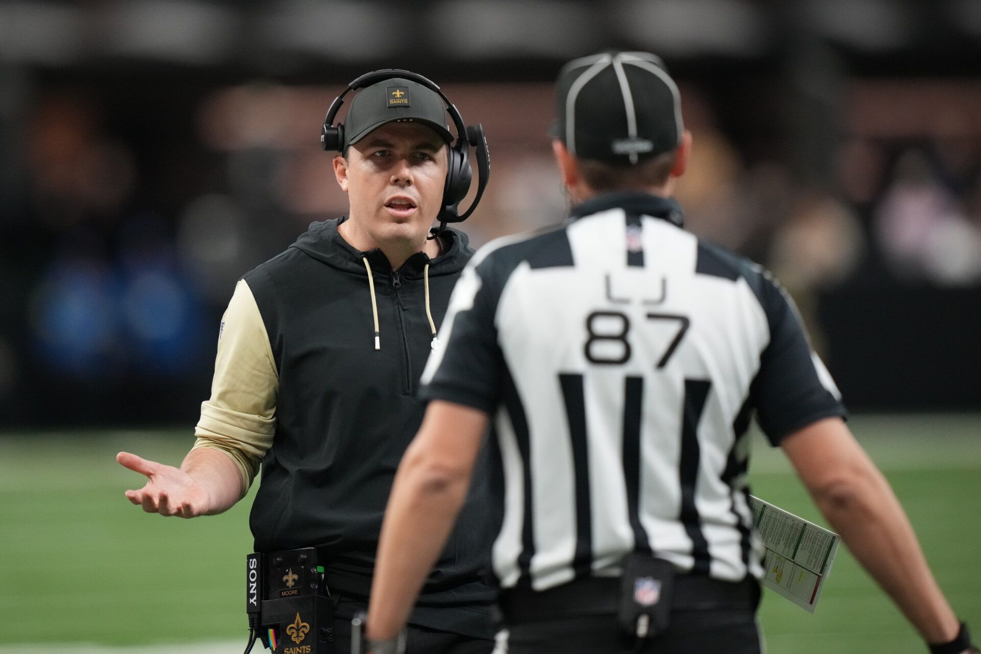 New Orleans Saints head coach Kellen Moore speaks to the referee after a flag on the play during the second quarter against the Carolina Panthers at Caesars Superdome.