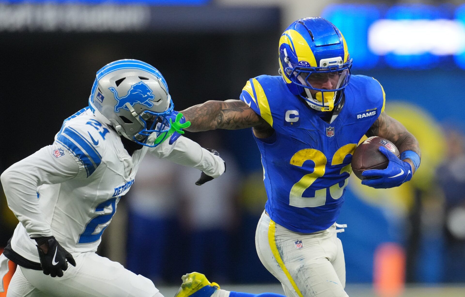 Los Angeles Rams running back Kyren Williams (23) runs the ball against Detroit Lions cornerback Amik Robertson (21) during the fourth quarter at SoFi Stadium.