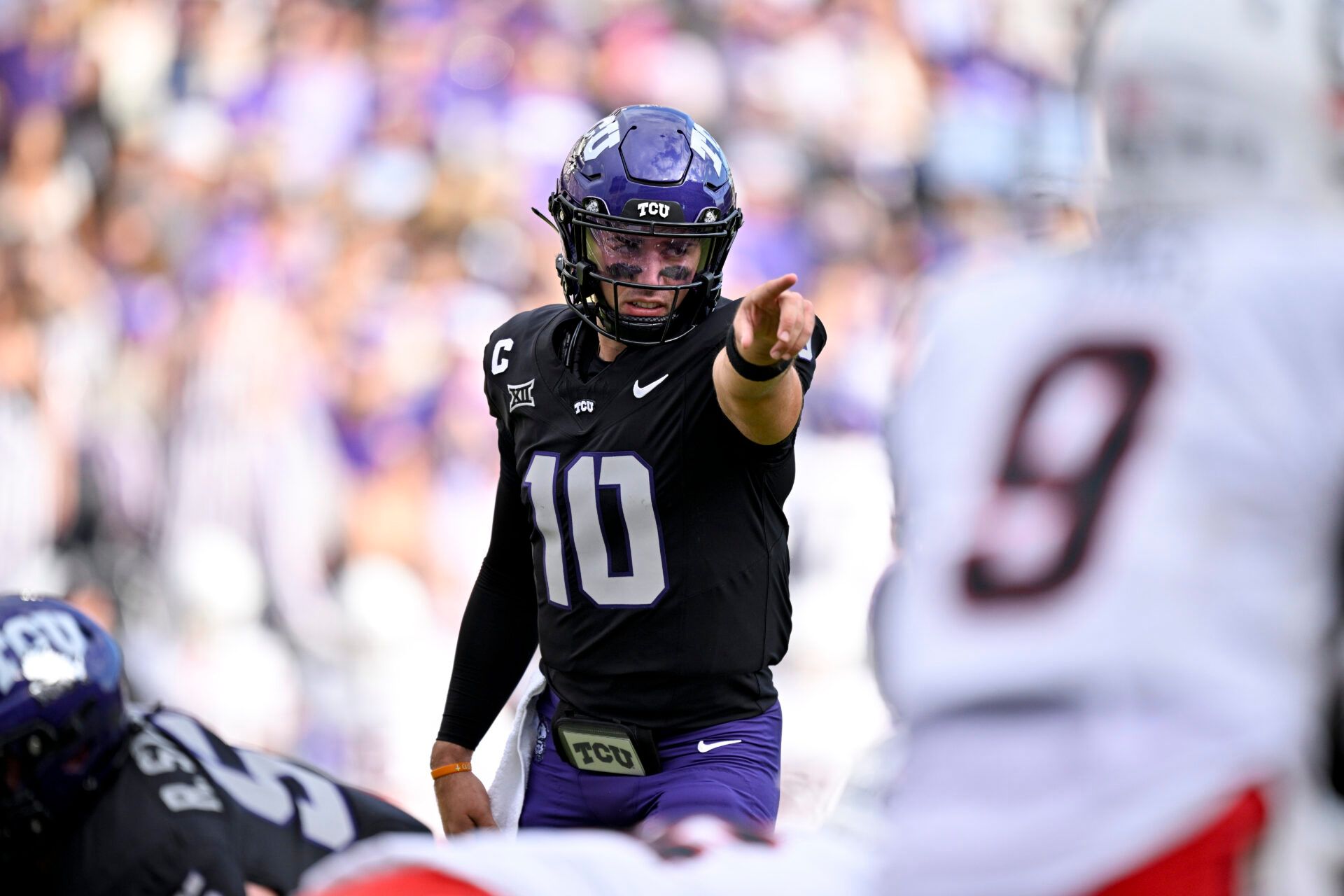 TCU Horned Frogs quarterback Josh Hoover (10) points to Cincinnati Bearcats defensive back Jiquan Sanks (9) during the first quarter at Amon G. Carter Stadium.