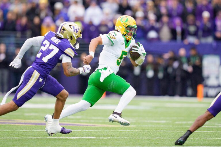 Oregon quarterback Dante Moore carries the ball as the Oregon Ducks take on the Washington Huskies on Nov. 29, 2025, at Husky Stadium in Seattle, Washington.
