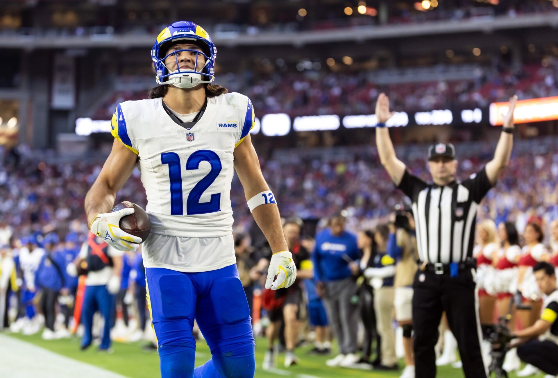 Los Angeles Rams wide receiver Puka Nacua (12) reacts after catching a touchdown against the Arizona Cardinals during the second half at State Farm Stadium.