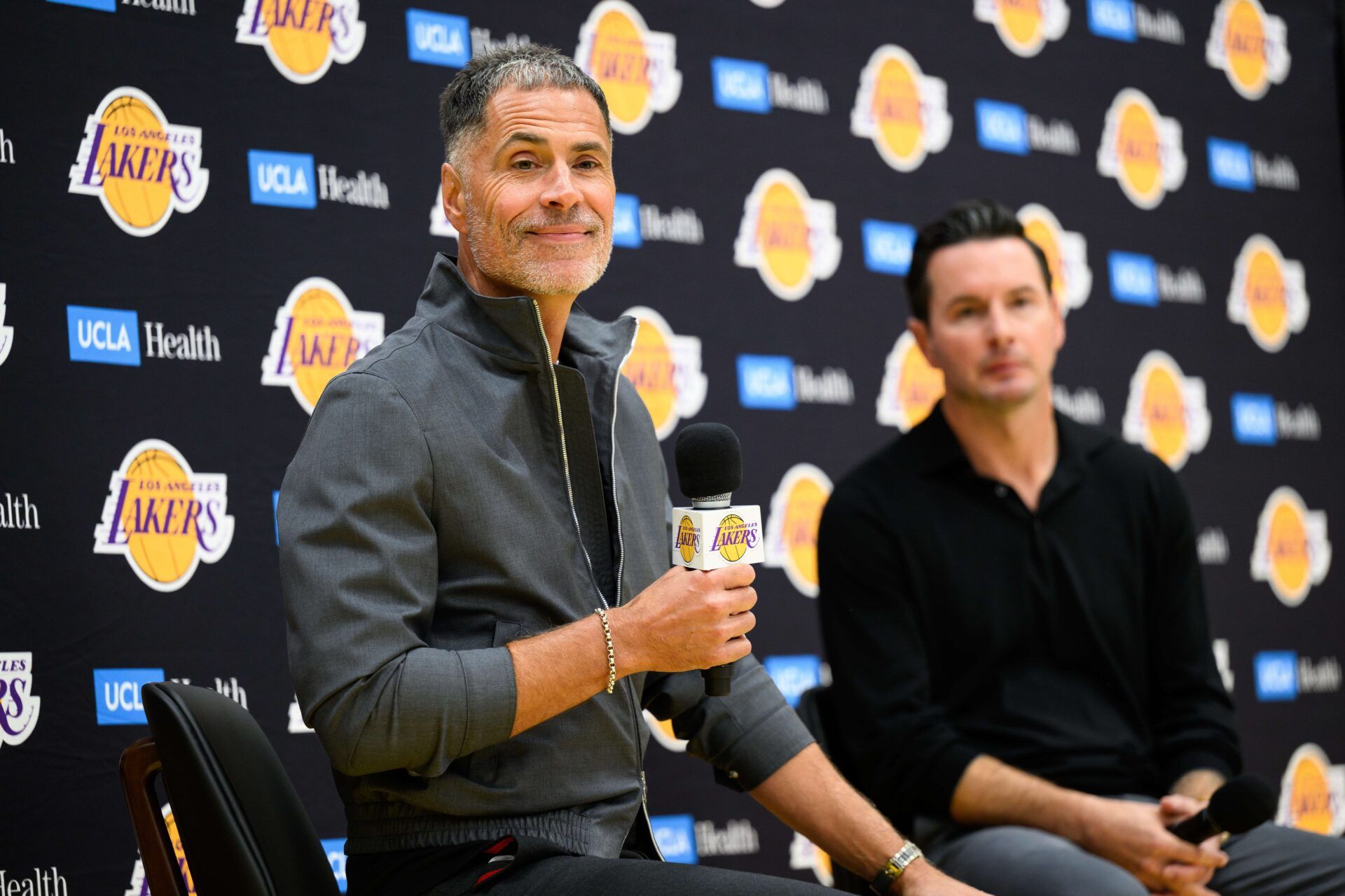 Los Angeles Lakers general manager Rob Pelinka, left, speaks during a press conference to preview the 2025-26 season at UCLA Health Training Center.