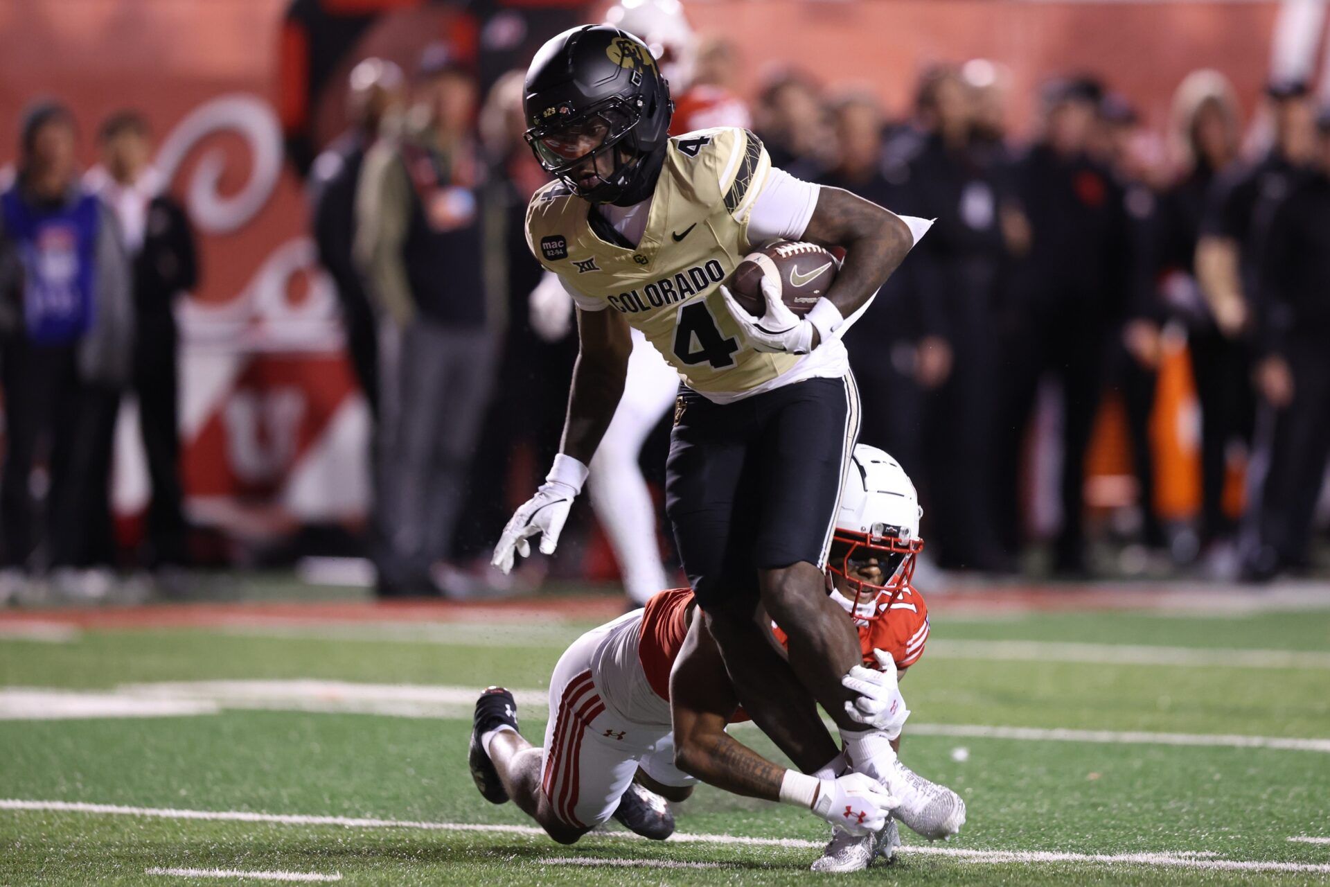 Colorado Buffaloes wide receiver Omarion Miller (4) is tackled by Utah Utes defensive back JC Hart (14) during the second half at Rice-Eccles Stadium.