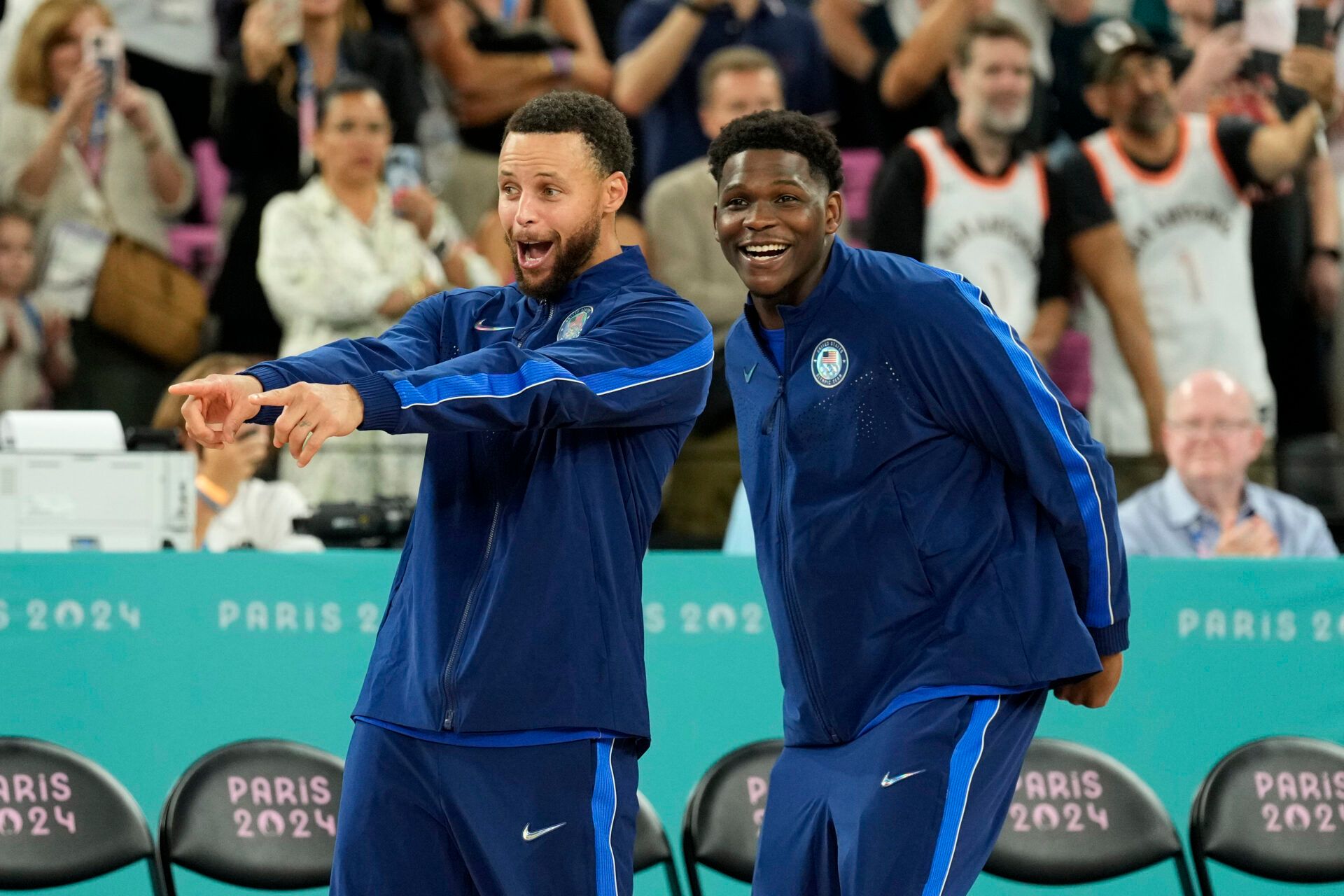 United States shooting guard Stephen Curry (4) and guard Anthony Edwards (5) celebrate after defeating France in the men's basketball gold medal game during the Paris 2024 Olympic Summer Games at Accor Arena.