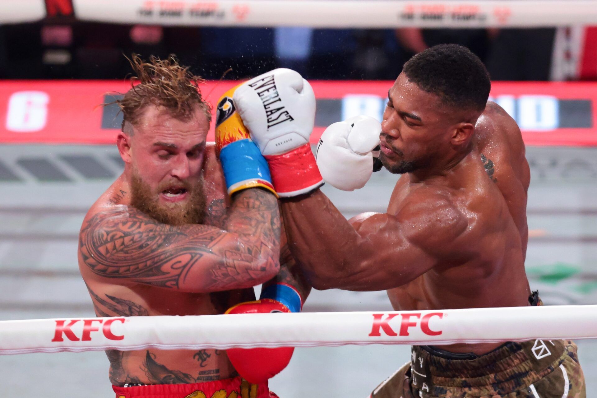 Anthony Joshua hits Jake Paul during a heavyweight boxing bout at Kayesa Center.