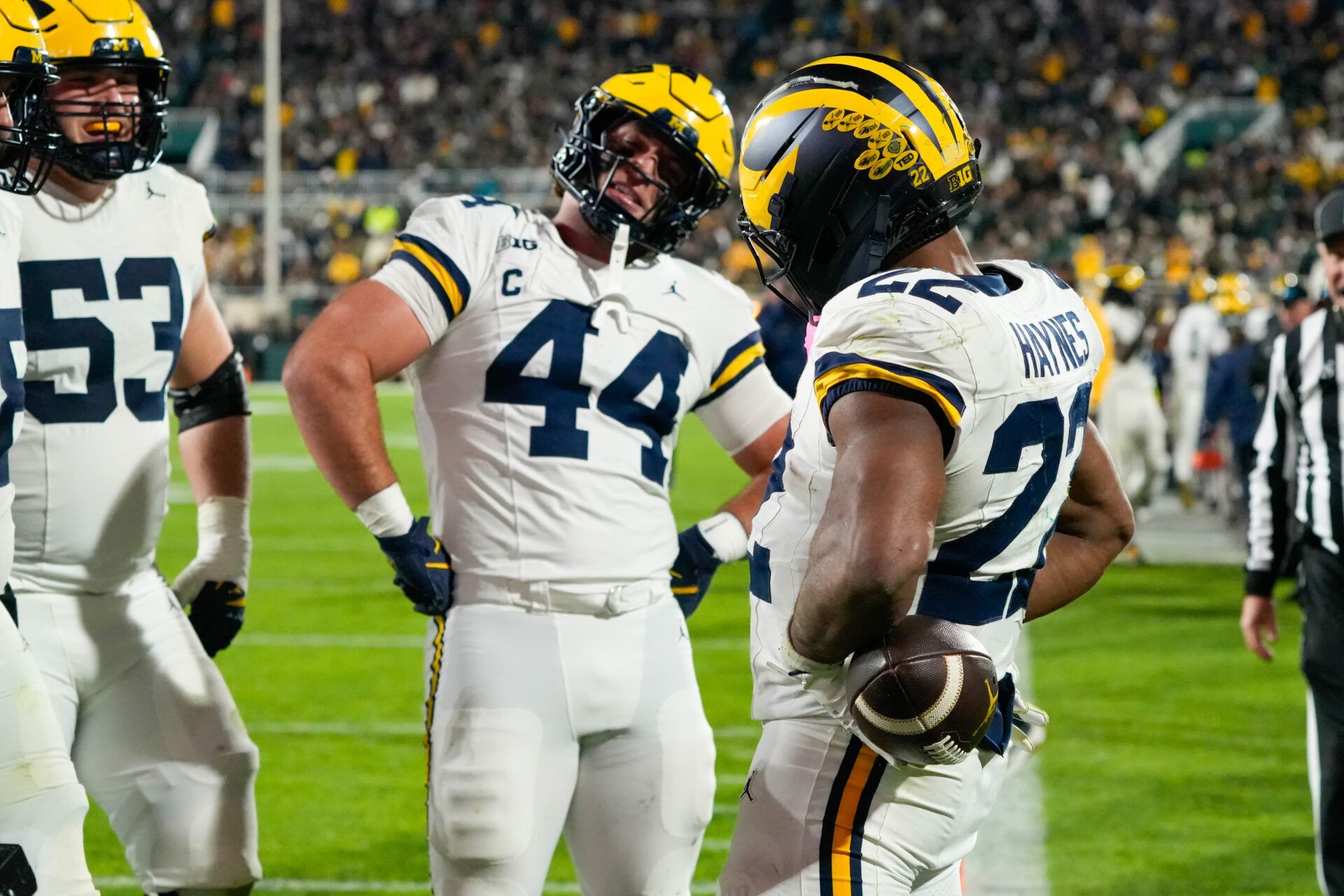 Michigan Wolverines running back Justice Haynes (22) reacts with tight end Max Bredeson (44) after scoring a touchdown against the Michigan Wolverines during the second half at Spartan Stadium.