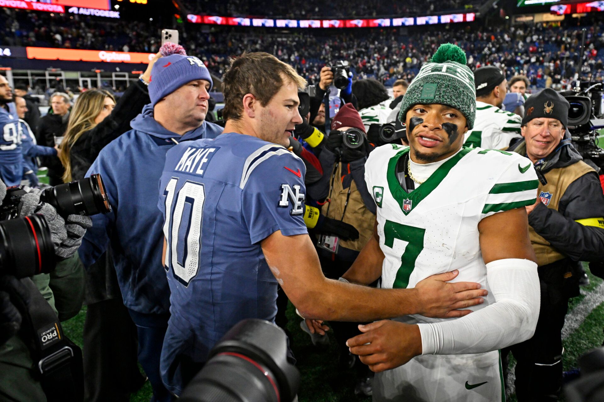 New England Patriots quarterback Drake Maye (10) and New York Jets quarterback Justin Fields (7) react after the game at Gillette Stadium.