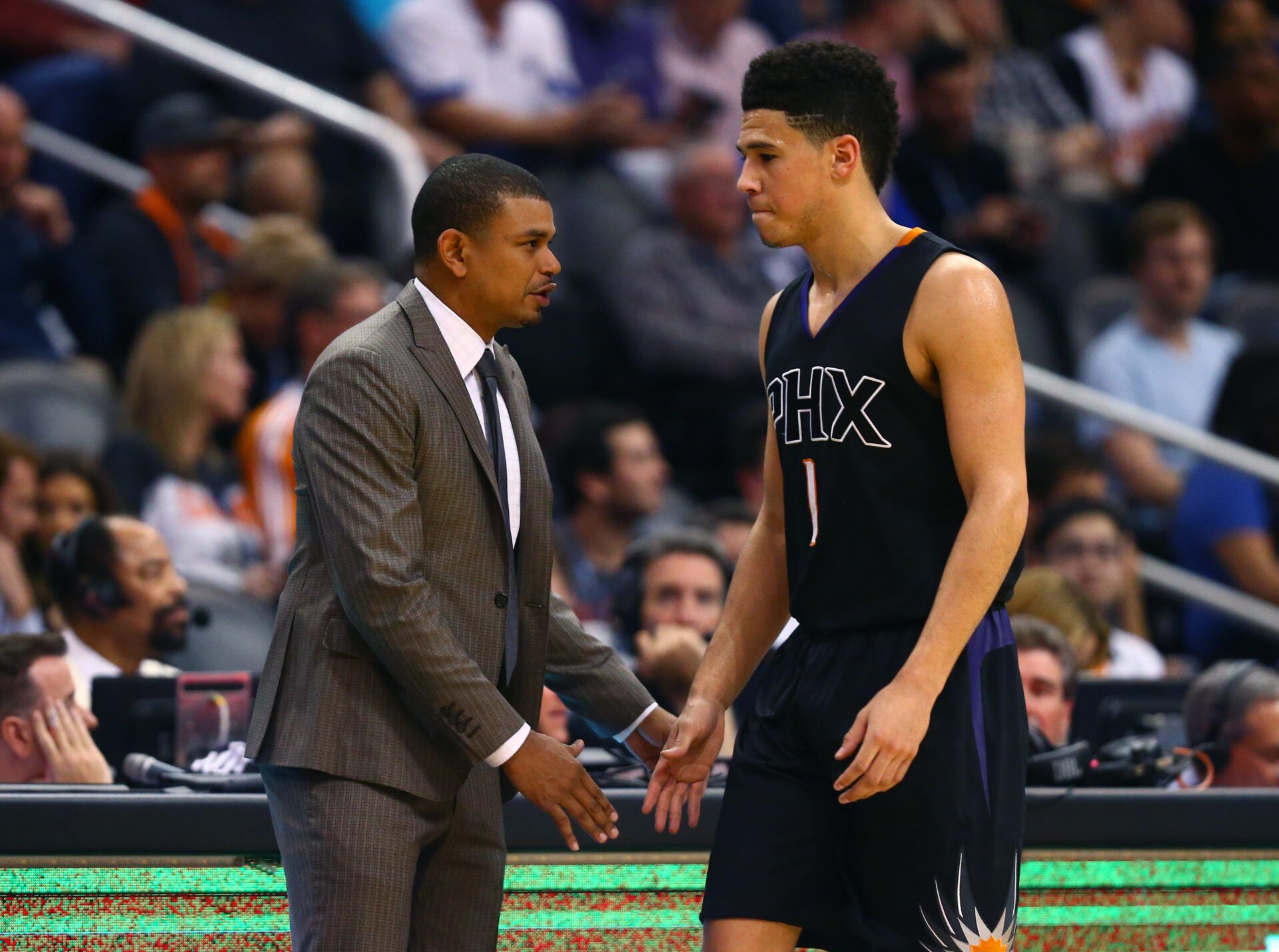 Phoenix Suns guard Devin Booker (1) and head coach Earl Watson against the New York Knicks at Talking Stick Resort Arena.