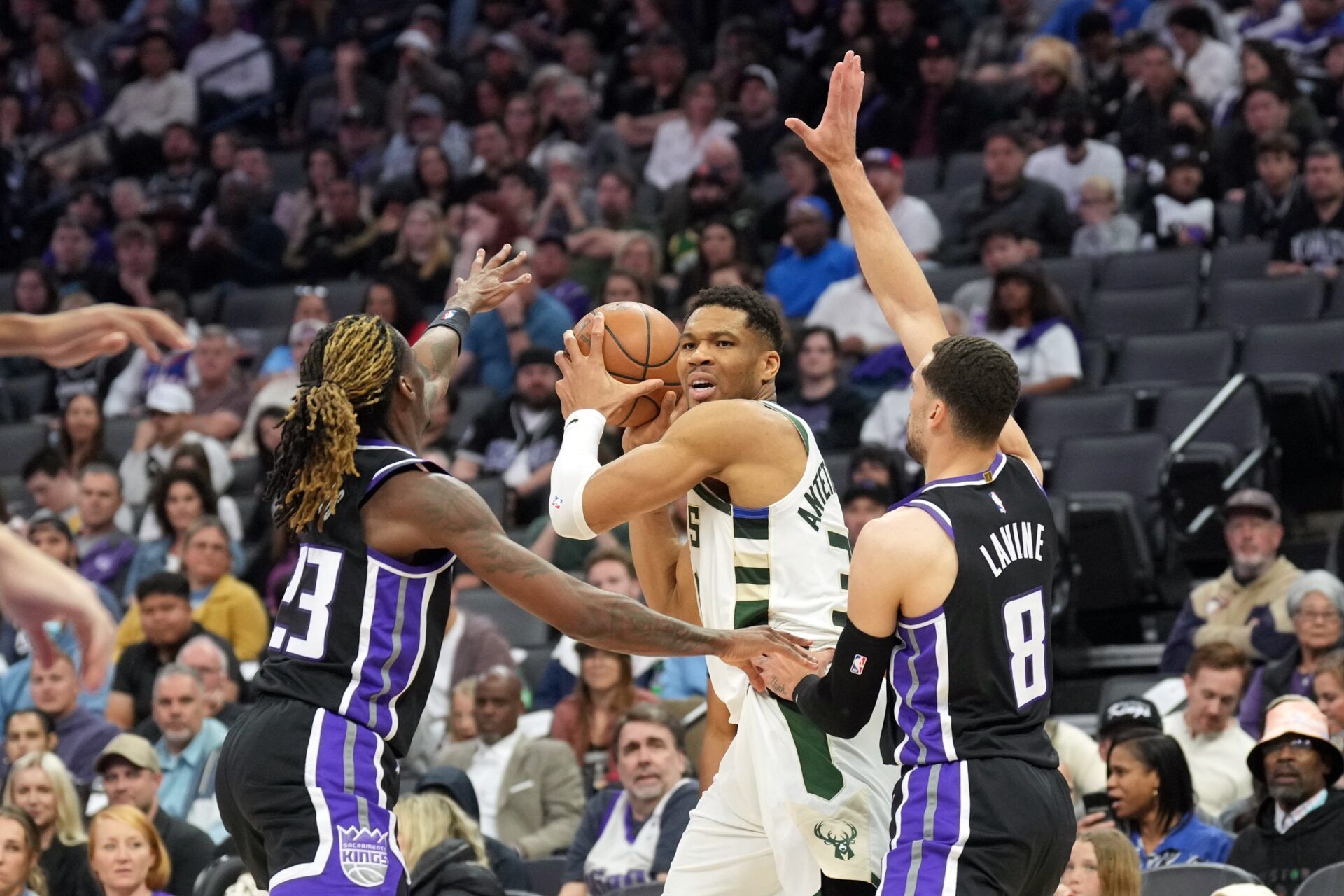 Milwaukee Bucks forward Giannis Antetokounmpo (center) is defended by Sacramento Kings guard Keon Ellis (left) and guard Zach LaVine (8) during the second quarter at Golden 1 Center.