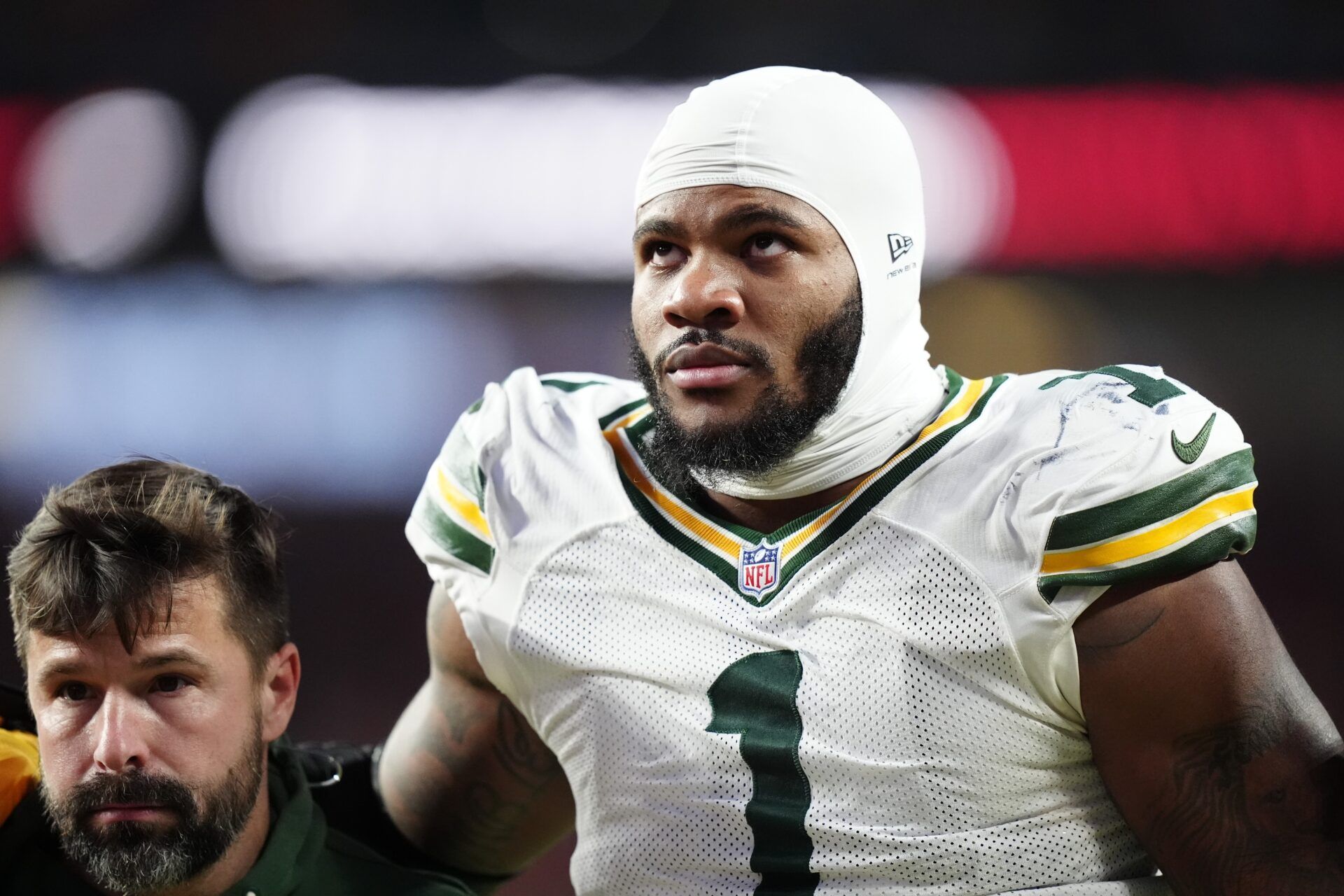 Green Bay Packers defensive end Micah Parsons (1) walks off the field with help from medical personnel following an injury during the third quarter against the Denver Broncos at Empower Field at Mile High.
