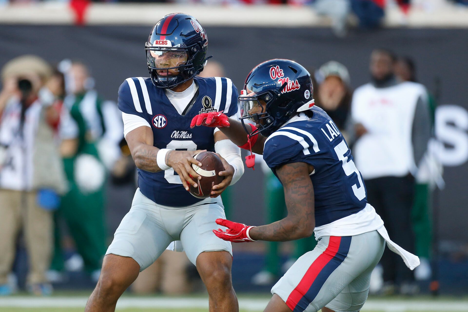 Mississippi Rebels quarterback Trinidad Chambliss (6) fakes the hand off to running back Kewan Lacy (5) against the Tulane Green Wave during the first half of a game at Vaught-Hemingway Stadium.
