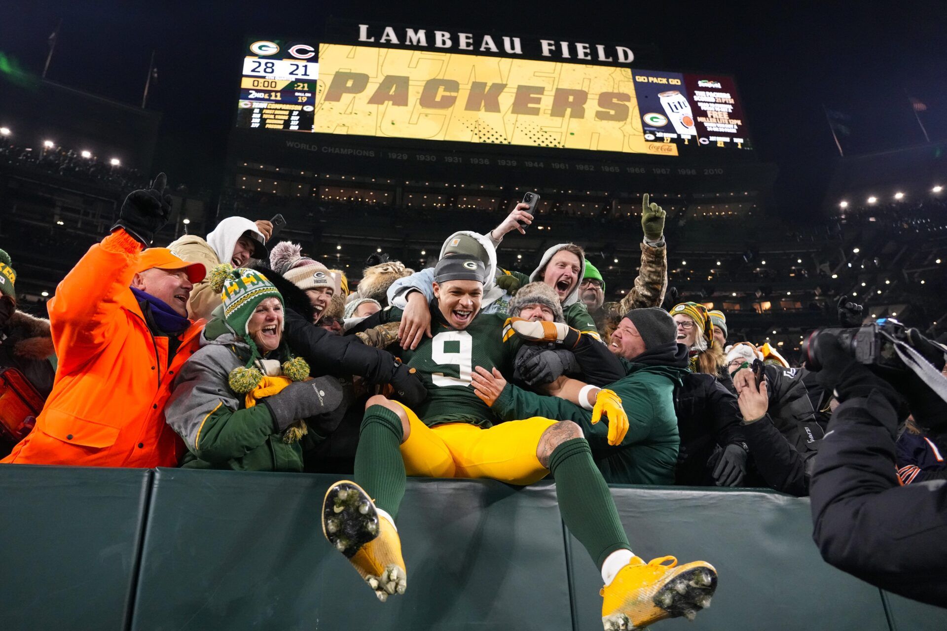 Green Bay Packers wide receiver Christian Watson (9) celebrates its fans following the game against the Chicago Bears at Lambeau Field.