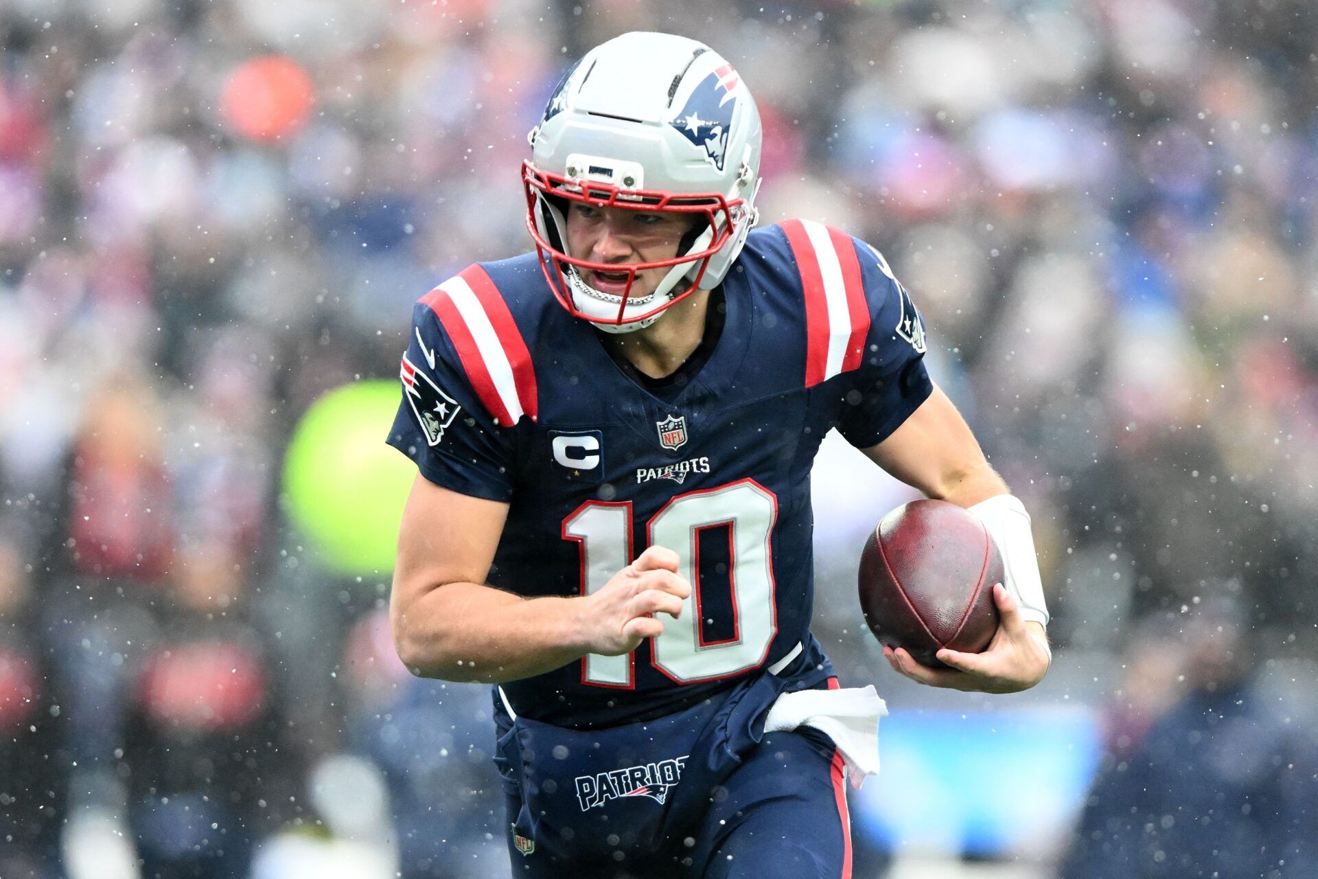 New England Patriots quarterback Drake Maye (10) runs against the Buffalo Bills during the first half at Gillette Stadium.