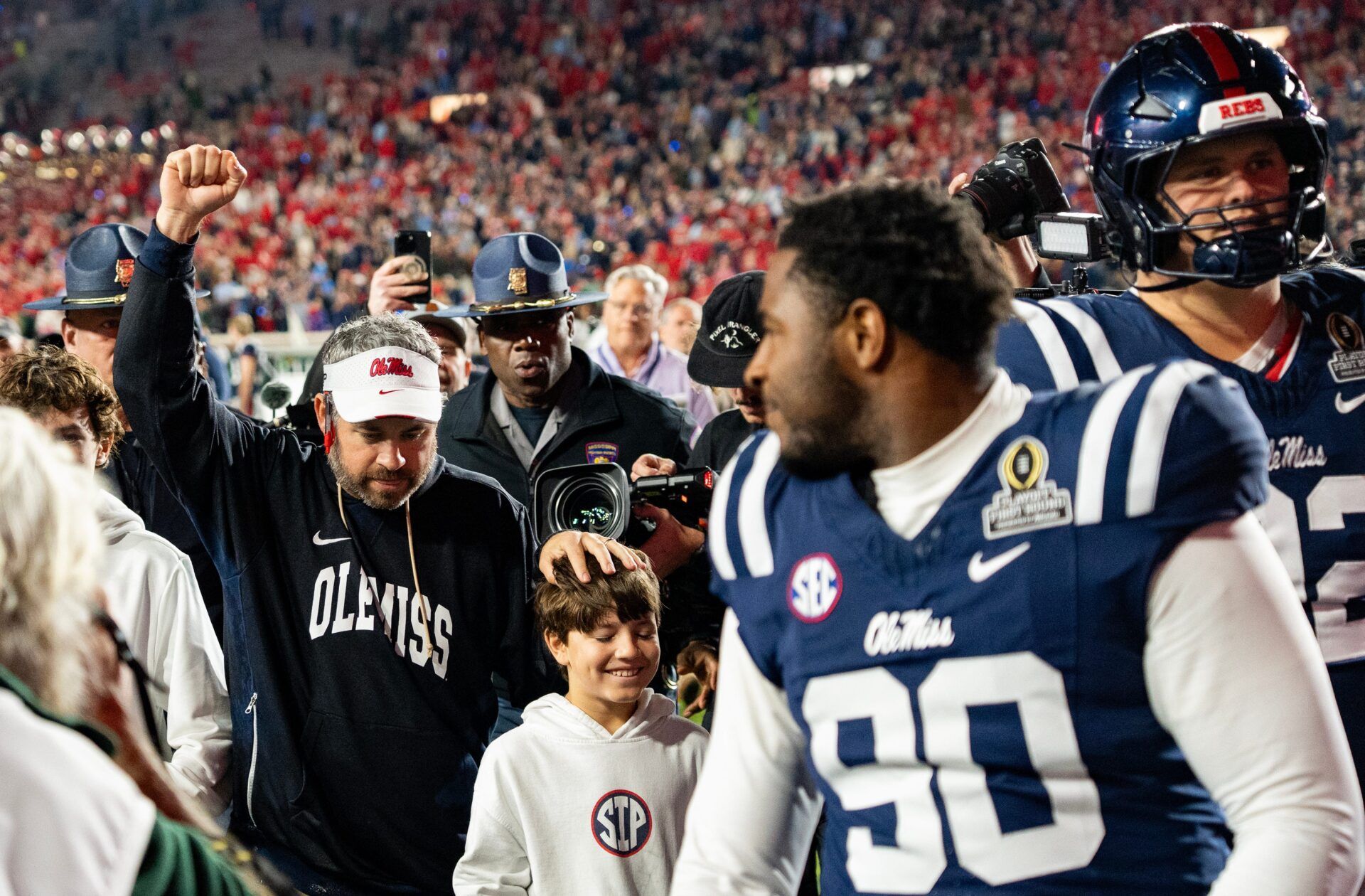 Ole Miss Head Coach Pete Golding raises a fist as he leaves the field after winning the first round of the College Football Playoff against Tulane at Vaught-Hemingway Stadium in Oxford, Miss., on Saturday, Dec. 20, 2025.