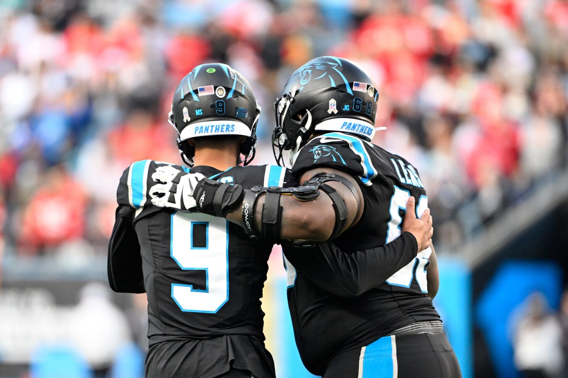 Carolina Panthers quarterback Bryce Young (9) with guard Damien Lewis (68) on the field in the fourth quarter at Bank of America Stadium.