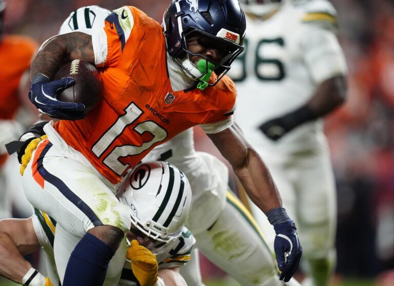 Denver Broncos running back RJ Harvey (12) runs for a touchdown during the fourth quarter against the Green Bay Packers at Empower Field at Mile High.