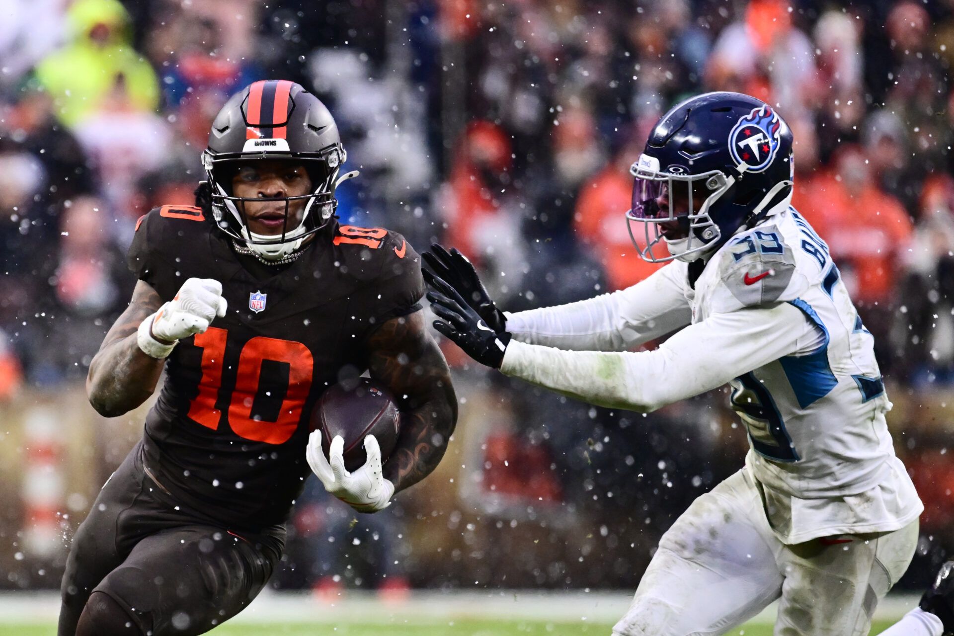 Cleveland Browns running back Quinshon Judkins (10) runs with the ball as Tennessee Titans cornerback Darrell Baker Jr. (39) defends during the third quarter at Huntington Bank Field.