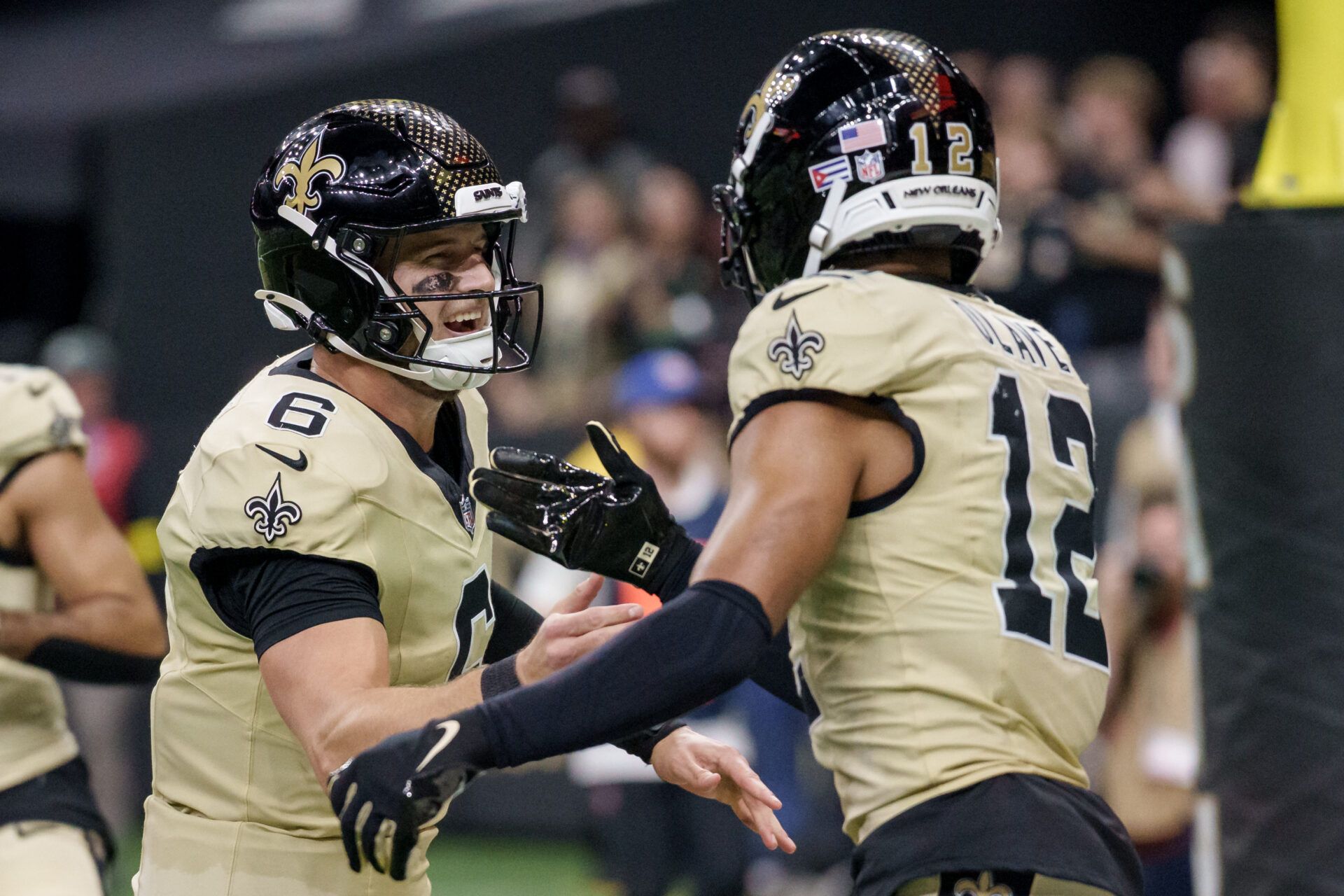 New Orleans Saints wide receiver Chris Olave (12) celebrates a touchdown against the New York Jets with New Orleans Saints quarterback Tyler Shough (6) during the third quarter at Caesars Superdome.