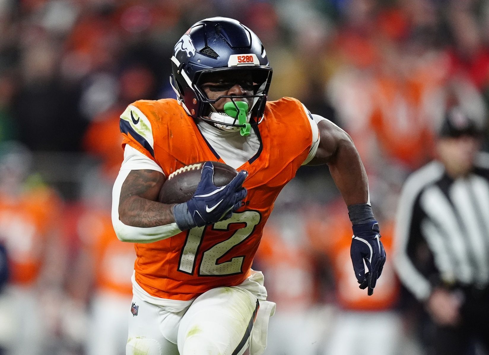 Denver Broncos running back RJ Harvey (12) runs for a gain during the fourth quarter against the Green Bay Packers at Empower Field at Mile High.