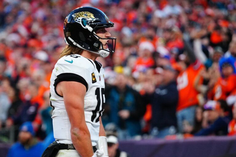 Jacksonville Jaguars quarterback Trevor Lawrence (16) reacts after rushing for a touchdown against the Denver Broncos during the second at Empower Field at Mile High.