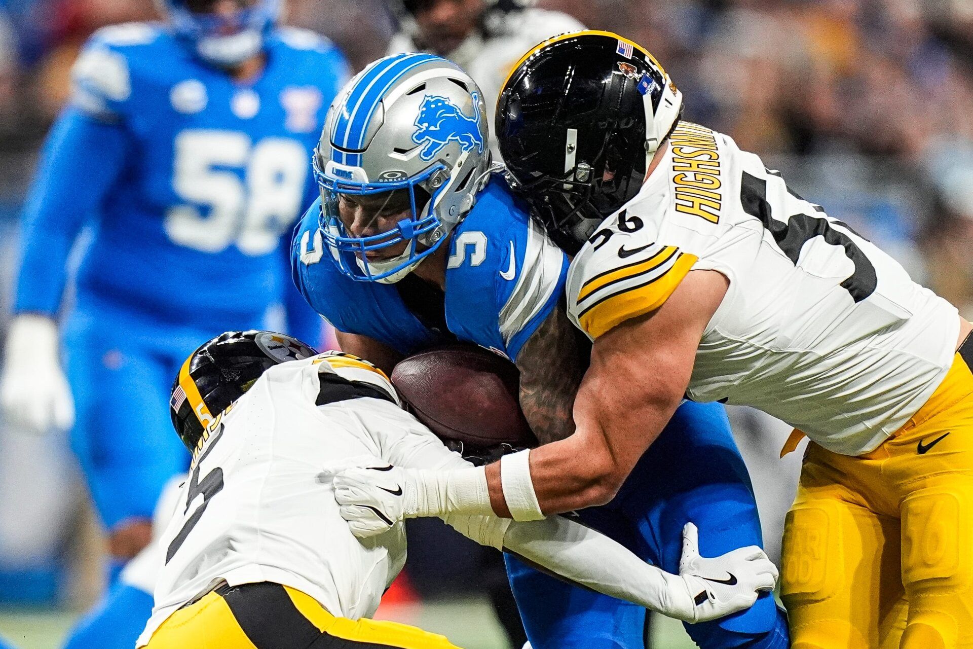 Detroit Lions running back David Montgomery (5) runs against Pittsburgh Steelers linebacker Alex Highsmith (56) and cornerback Jalen Ramsey (5) during the first half at Ford Field in Detroit on Sunday, Dec. 21, 2025.