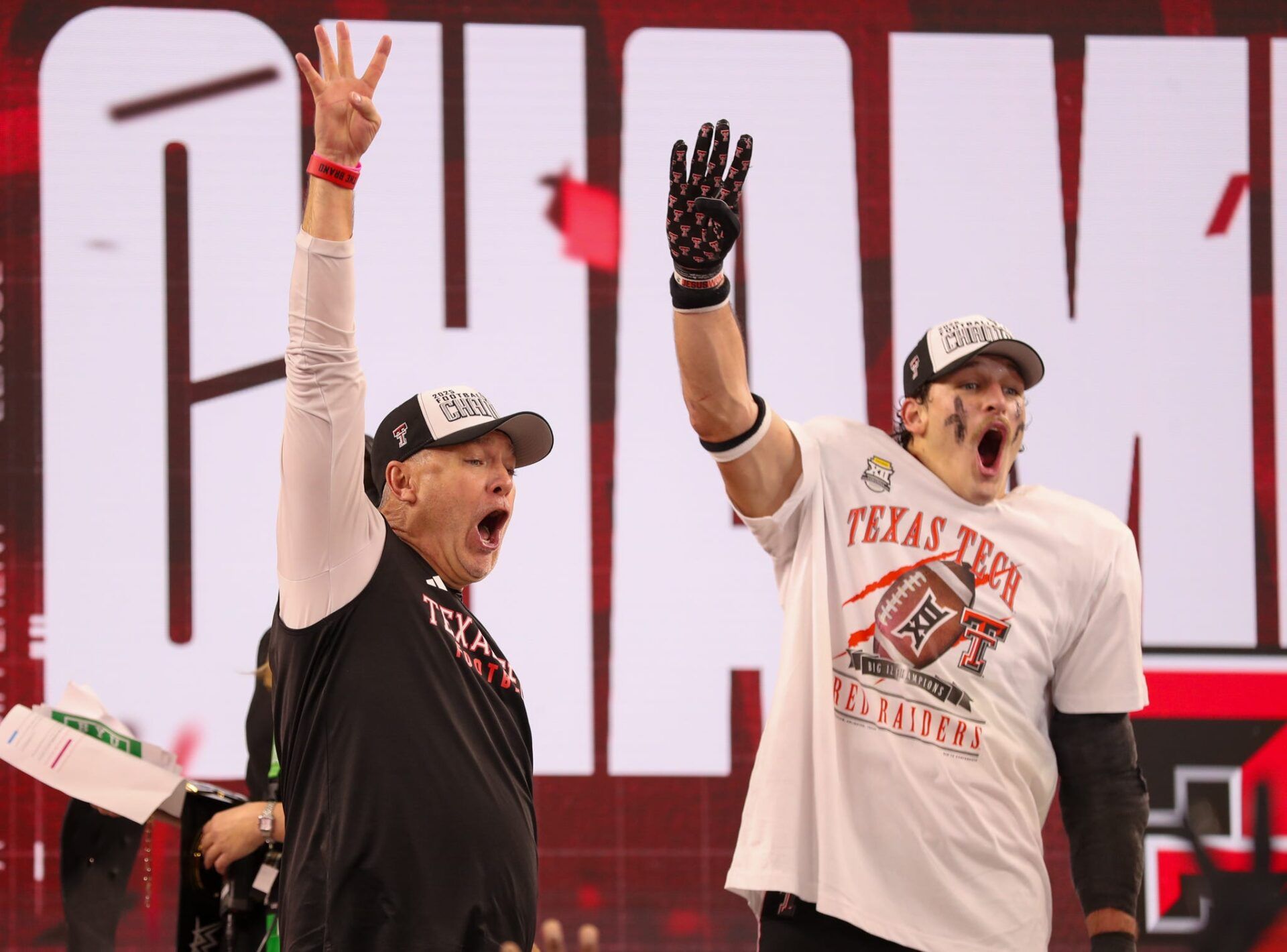 Texas Tech head coach Joey McGuire and linebacker Ben Roberts hold up four fingers after beating BYU in the Big 12 Conference championship game, Saturday, Nov. 6, 2025, at AT&T Stadium in Arlington.