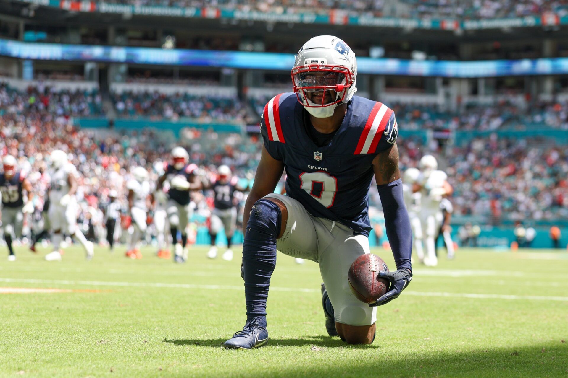 New England Patriots wide receiver Kayshon Boutte (9) races after scoring a touchdown against the Miami Dolphins in the first quarter  at Hard Rock Stadium.