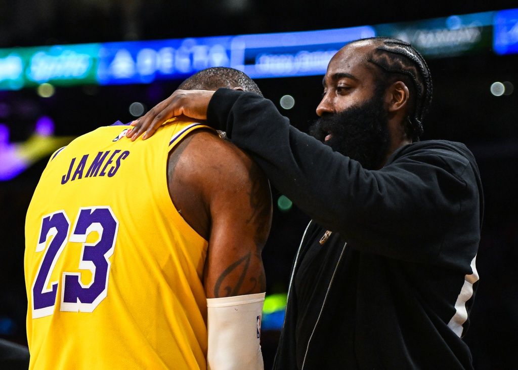 LA Clippers guard James Harden (1) greets Los Angeles Lakers forward LeBron James (23) on the sidelines during the fourth quarter at Crypto.com Arena.