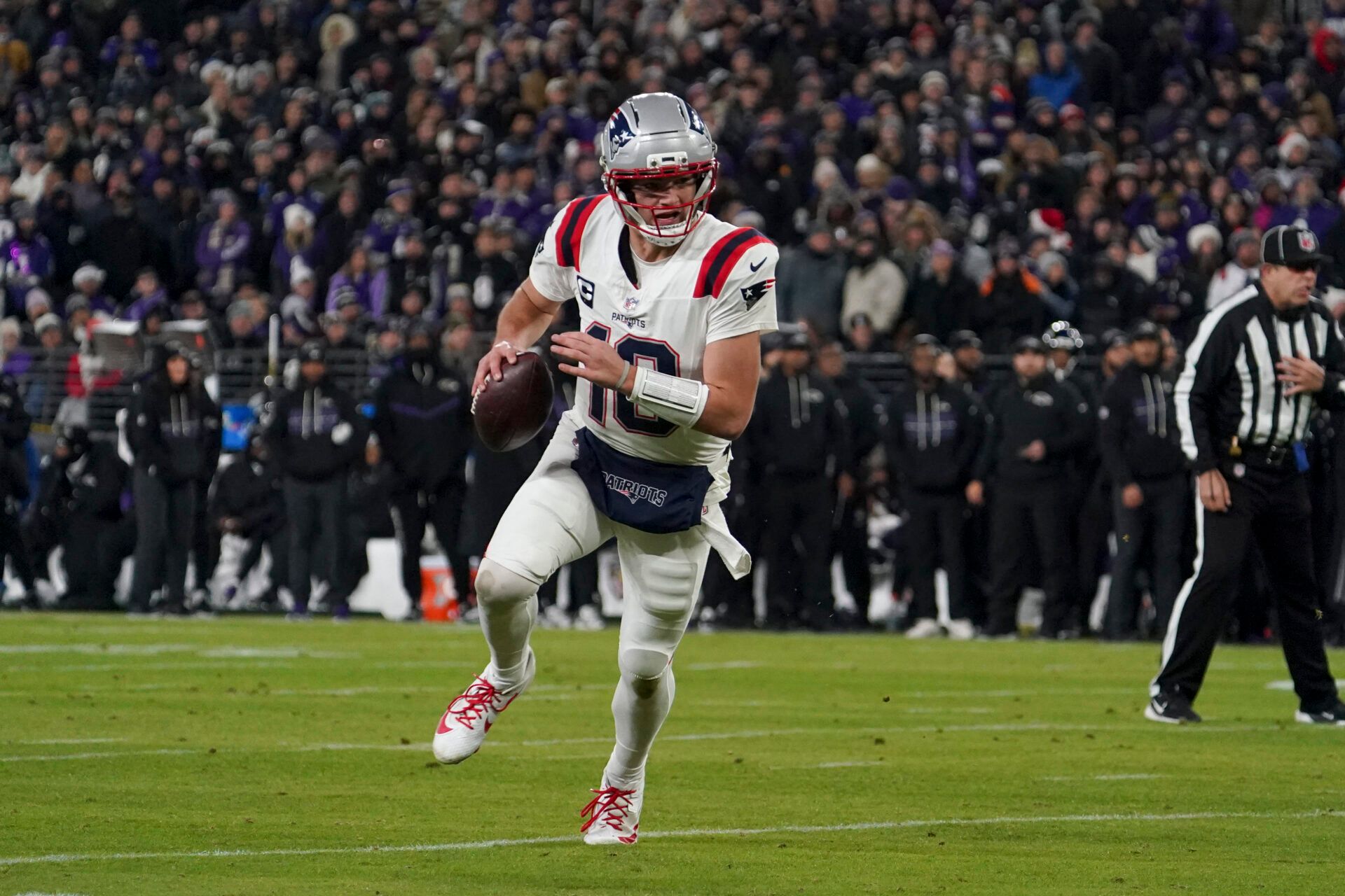 New England Patriots halfback Drake Maye (10) runs the ball against the Baltimore Ravens during the first half of the game at M&T Bank Stadium.