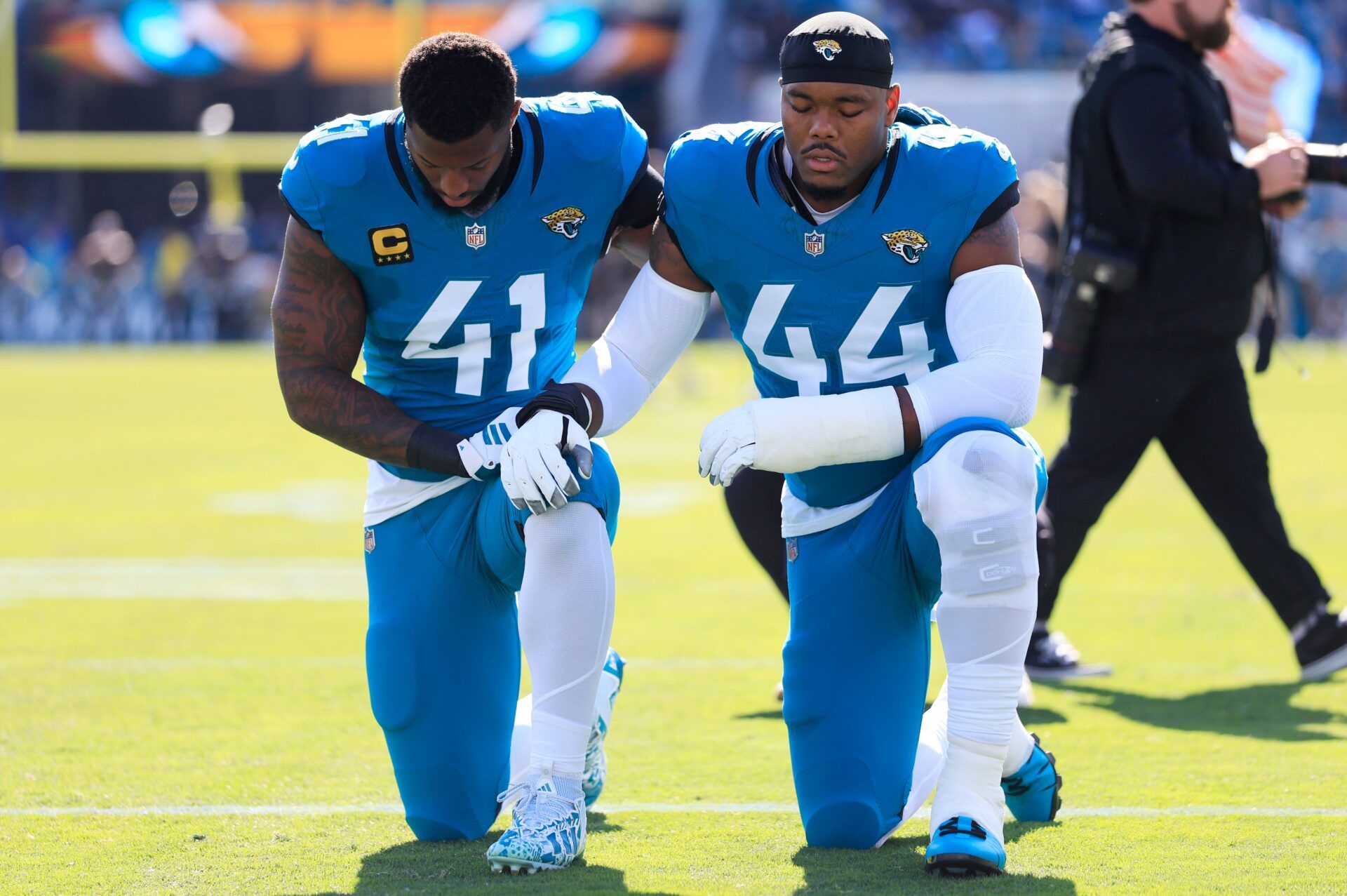 Jacksonville Jaguars defensive end Josh Hines-Allen (41) and defensive end Travon Walker (44) pray before an NFL football matchup at EverBank Stadium, Sunday, Dec. 14, 2025, in Jacksonville, Fla. The Jaguars defeated the Jets 48-20. [Corey Perrine/Florida Times-Union]