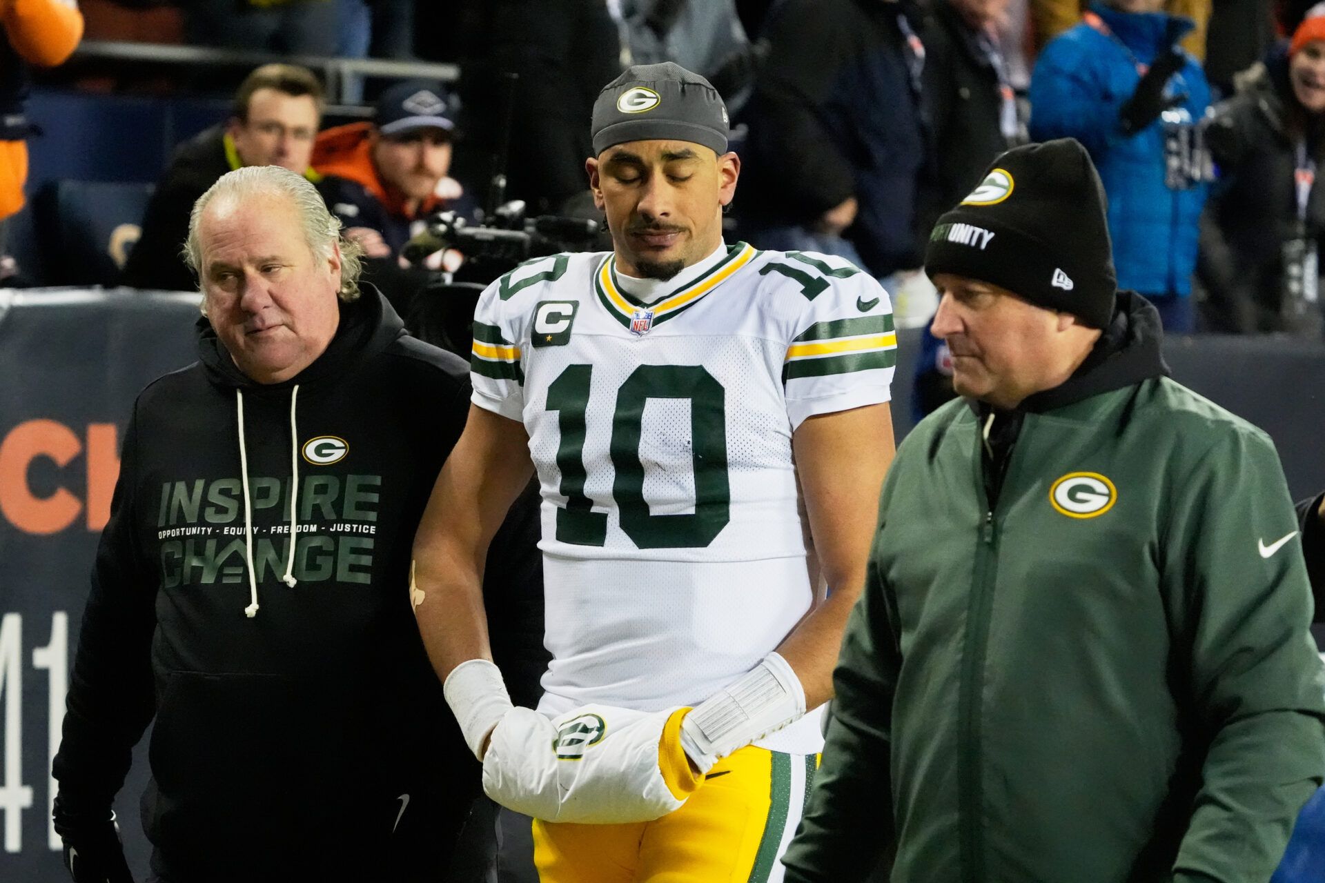 Green Bay Packers quarterback Jordan Love (10) walks off the field with an apparent injury against the Chicago Bears during the second quarter at Soldier Field.