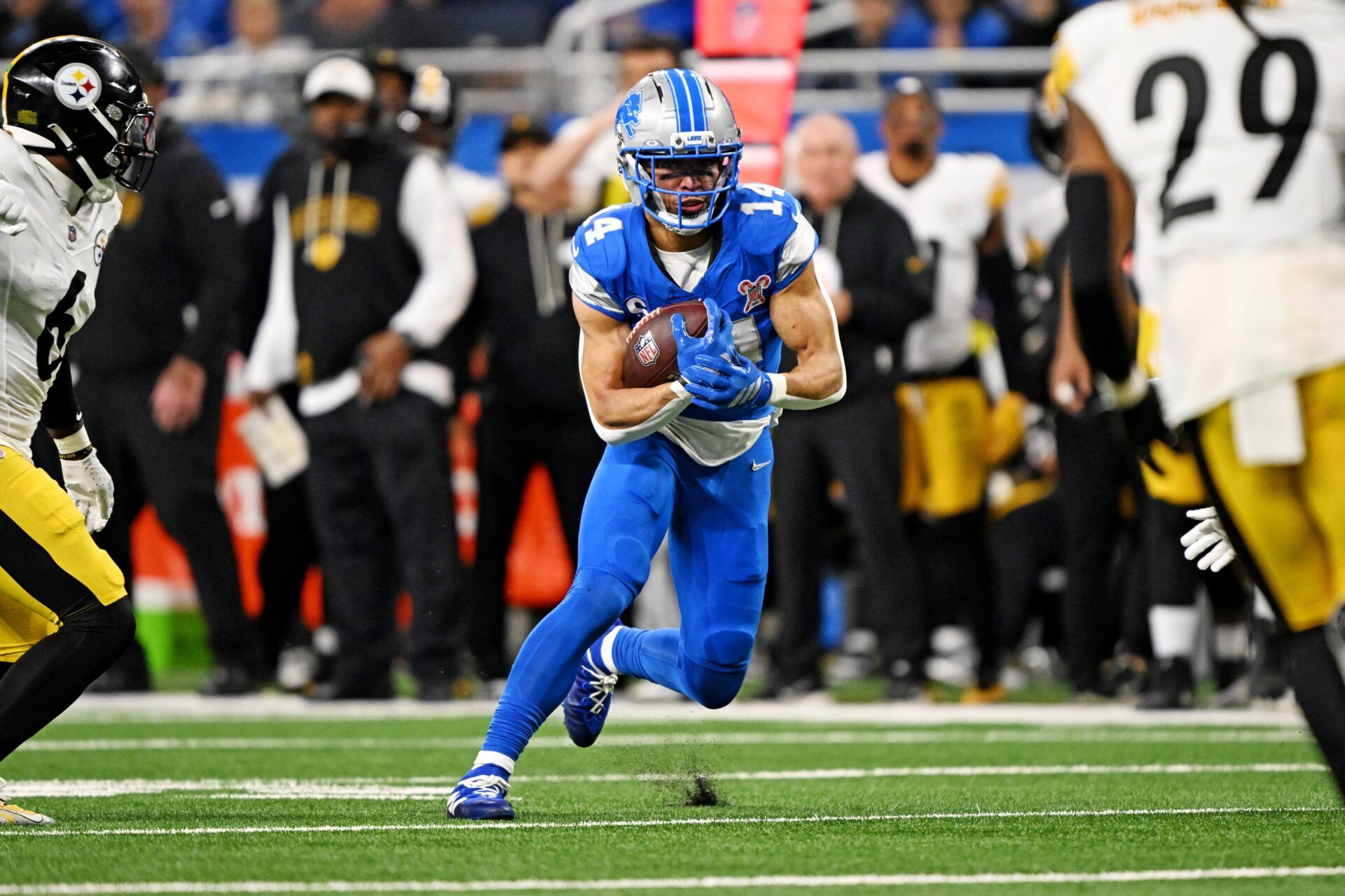 Detroit Lions wide receiver Amon-Ra St. Brown (14) runs the ball during the second quarter against the Pittsburgh Steelers at Ford Field.